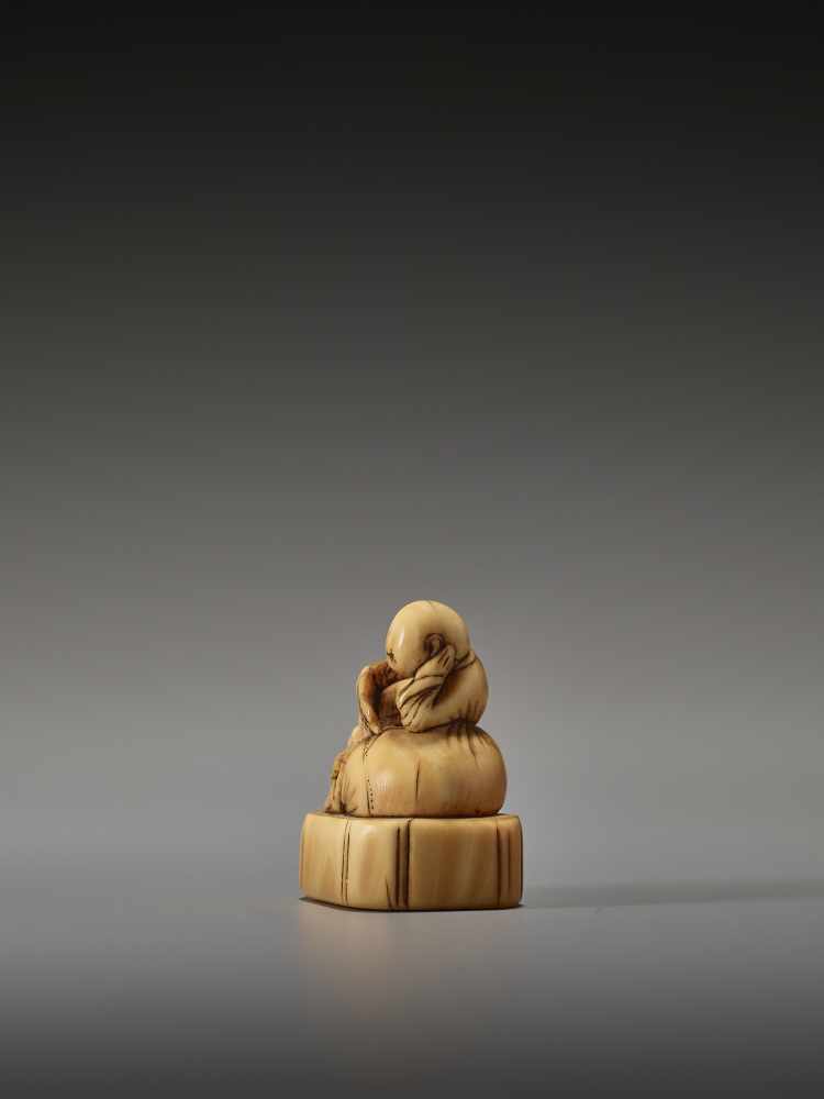 AN EARLY IVORY NETSUKE OF A CHINESE BOY ON HOTEI’S SACKUnsigned, ivory netsukeJapan, 18th century, - Image 3 of 6