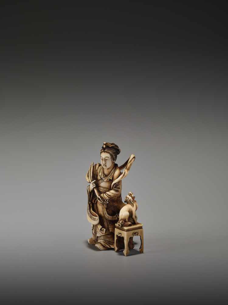 A FINE NETSUKE OKIMONO OF A CHINESE IMMORTAL WITH MYTHICAL DOG BY TEIMINBy Teimin, ivory okimono- - Image 3 of 9