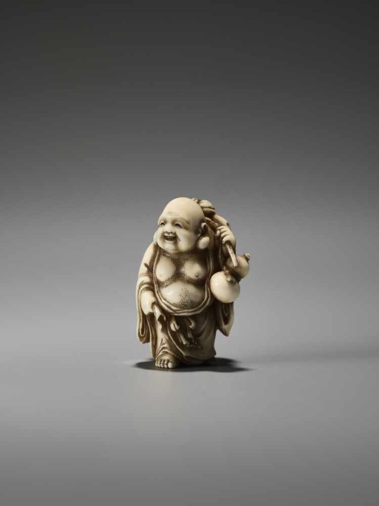 A FINE IVORY NETSUKE OF HOTEI BY MEIKEISAI HOJITSUBy Meikeisai Hojitsu, ivory netsukeJapan, Tokyo,