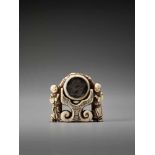 A RARE AND UNUSUAL IVORY NETSUKE OF TWO CHINESE BOYS AT A PALACE GONGUnsigned, ivory netsuke with