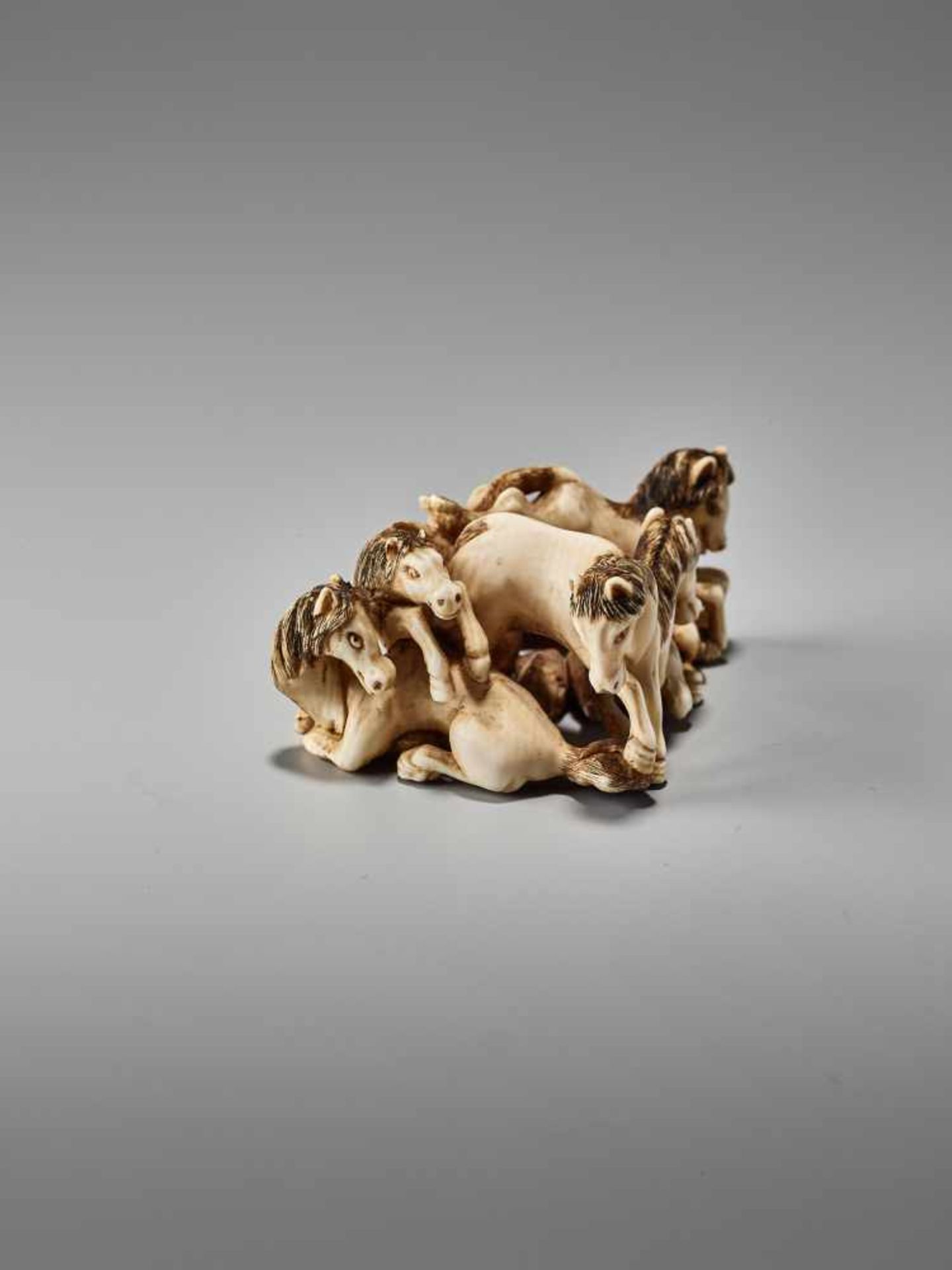 AN IVORY NETSUKE OF FIVE STALLIONS BY SHOGETSUBy Shogetsu, ivory netsukeJapan, mid-19th century, Edo - Image 5 of 8