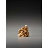 AN EARLY IVORY NETSUKE OF A CHINESE SAGE ON A LARGE BAGUnsigned, ivory netsukeJapan, 18th century,