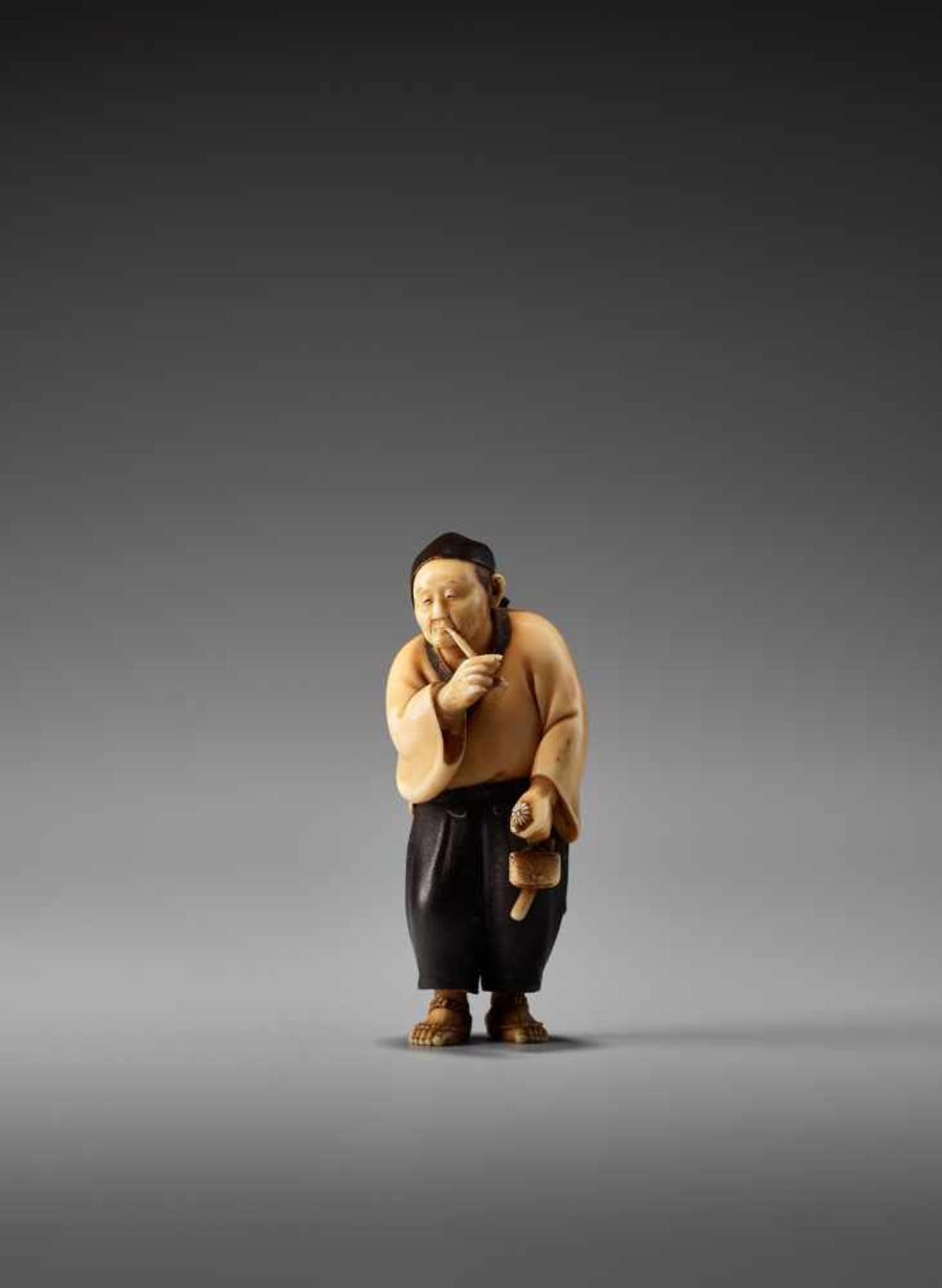 A SO SCHOOL IVORY NETSUKE OF A MAN SMOKING A PIPE BY SOSAIBy Sosai, ivory netsuke with lacquerJapan,