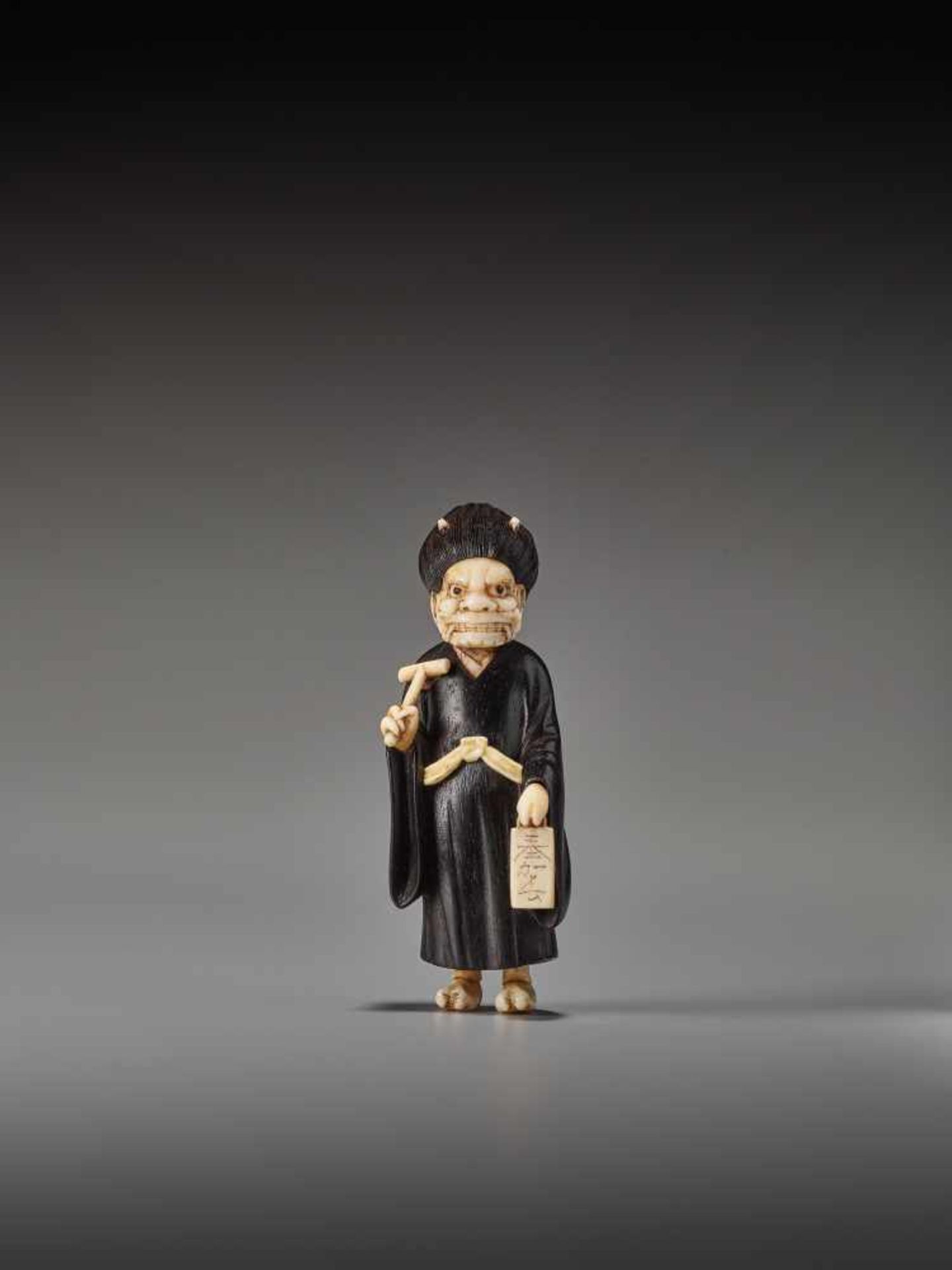 A RARE TOKYO SCHOOL EBONY AND IVORY NETSUKE OF ONI NEMBUTSU BY SADAYUKIBy Sadayuki, ebony wood and