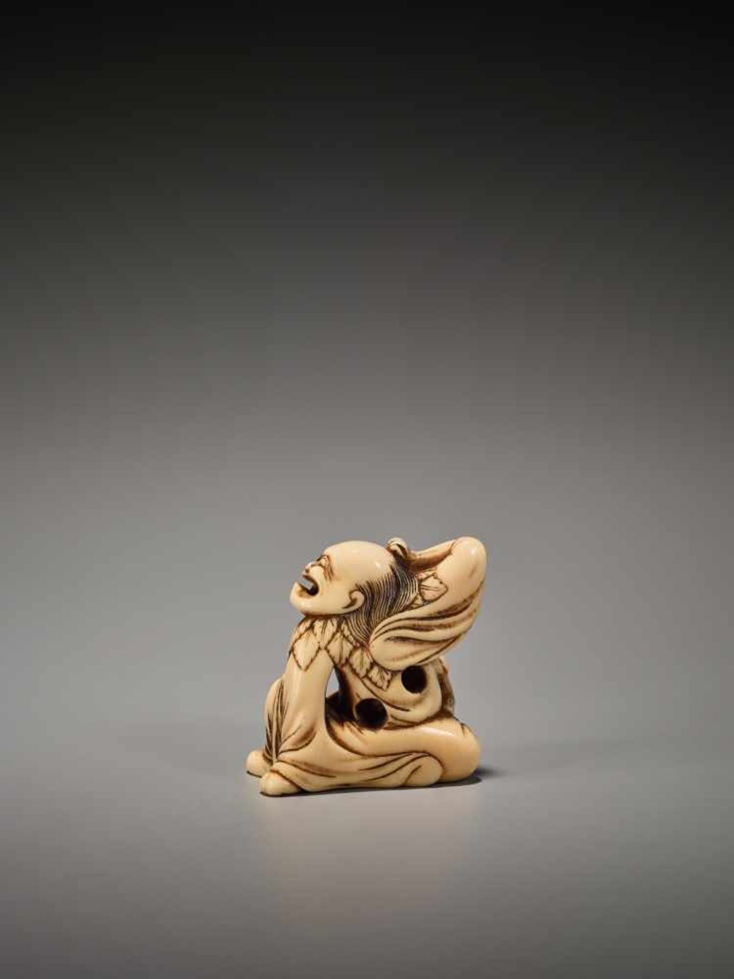 A POWERFUL IVORY NETSUKE OF A SENNIN WITH BOY AND PEACH Unsigned, ivory netsukeJapan, Kyoto, 18th - Image 2 of 6