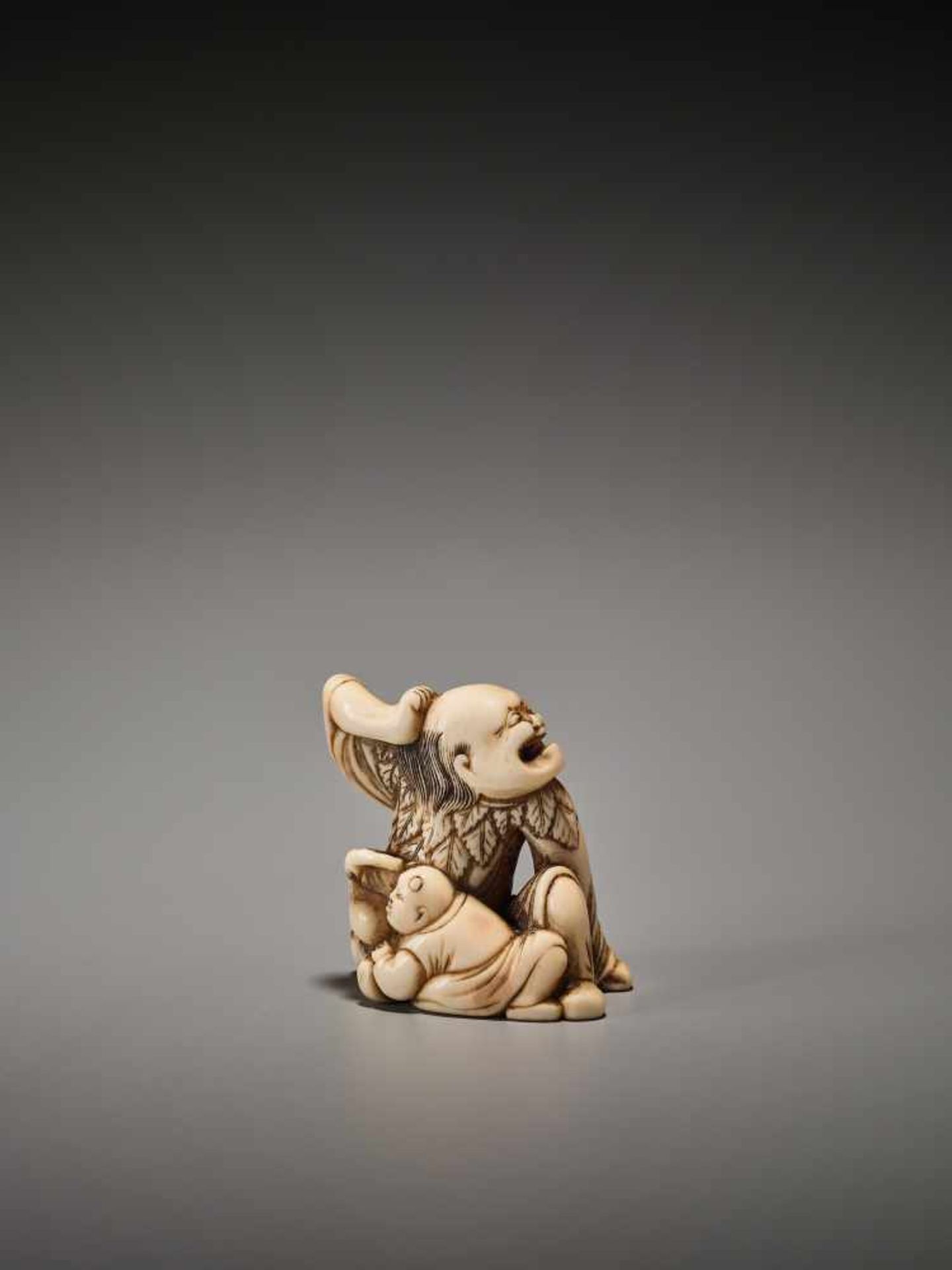 A POWERFUL IVORY NETSUKE OF A SENNIN WITH BOY AND PEACH Unsigned, ivory netsukeJapan, Kyoto, 18th