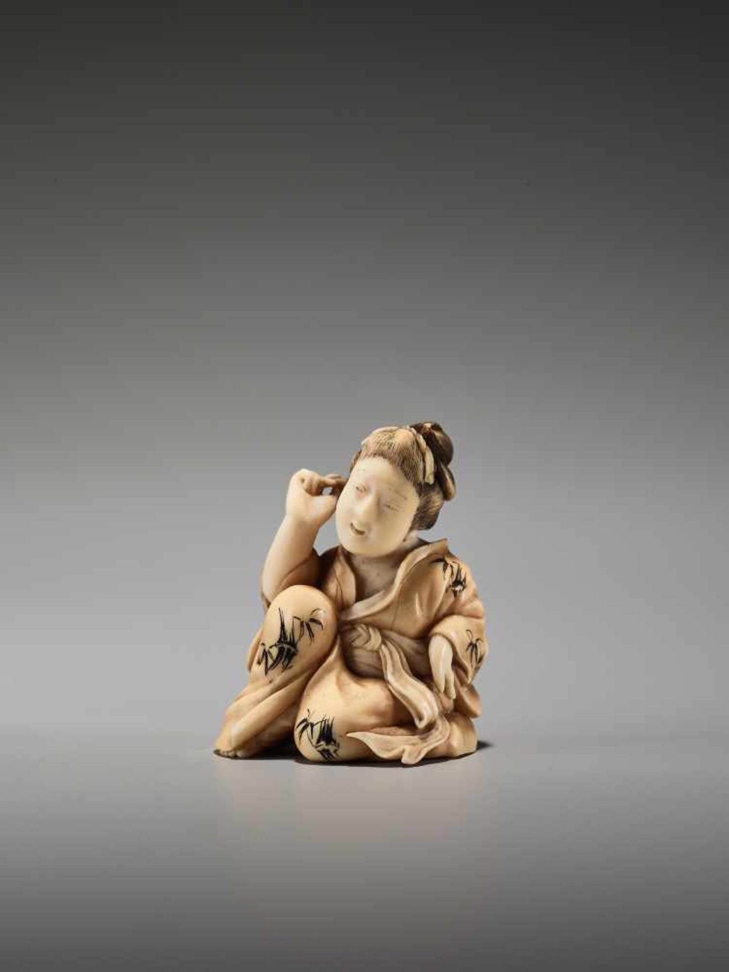 AN IVORY SHUNGA NETSUKE OF A BIJIN BY KOHOSAIBy Kohosai, ivory shunga netsuke with some