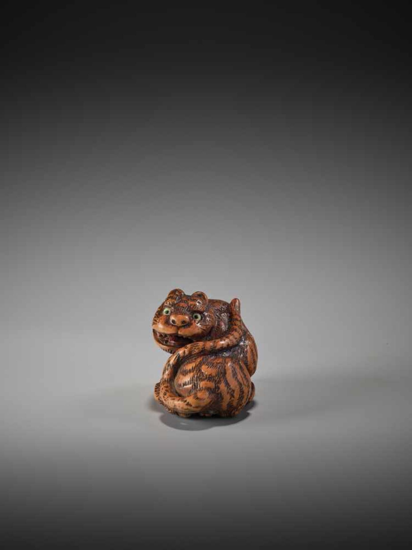 A WOOD NETSUKE OF A TIGER BY TANAKA MINKO (1735-1816)By Minko, wood netsukeJapan, Tsu, Ise province,