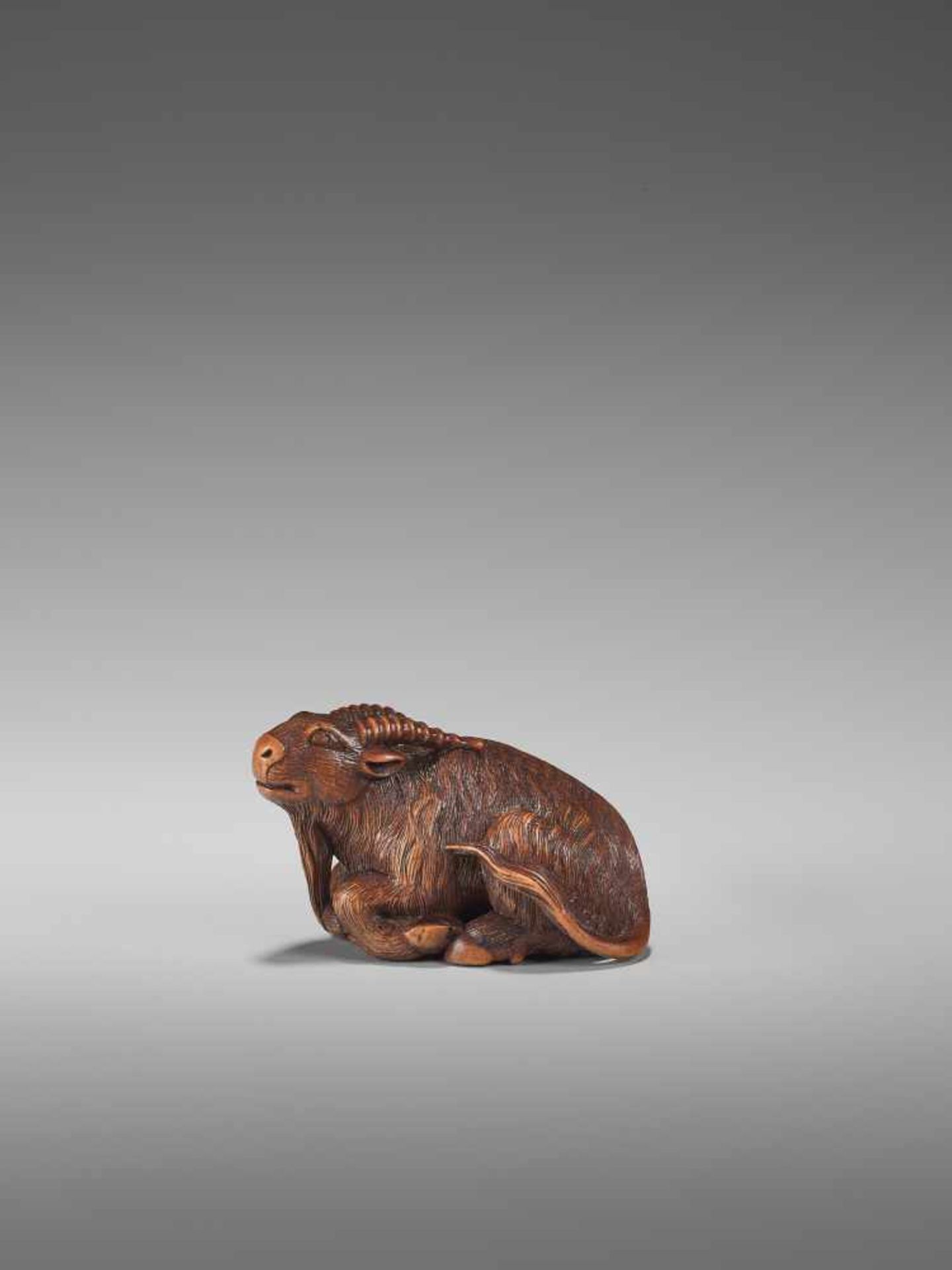 A FINE WOOD NETSUKE OF A GOAT BY KOKEIBy Kokei, wood netsukeJapan, Kuwana, Ise province, early