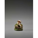 A FINE TOKYO-SCHOOL IVORY NETSUKE OF A MAN WITH GLASSES AND AN ABACUS BY YASUMASABy Yasumasa (