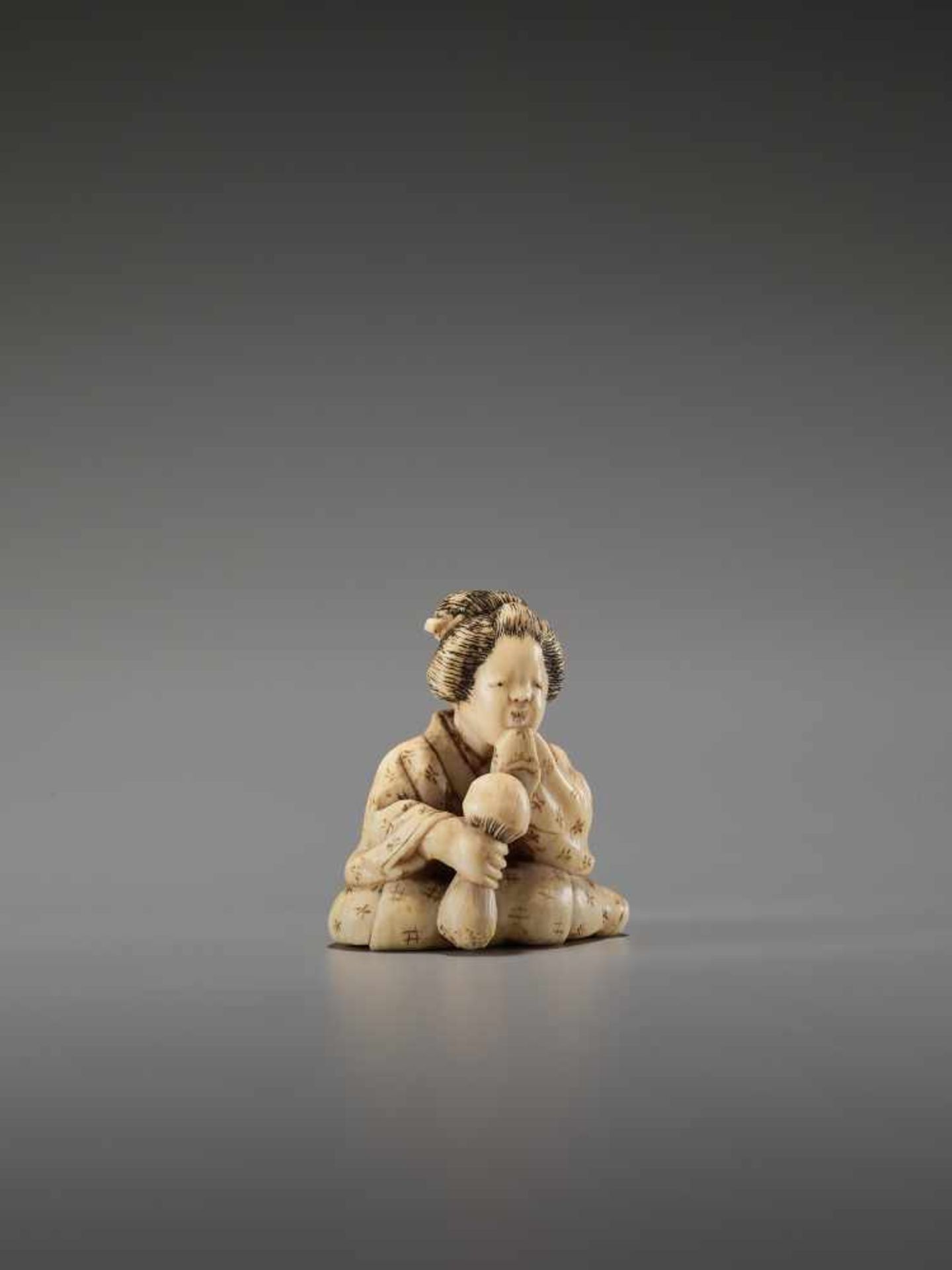 AN IVORY SHUNGA NETSUKE OF A LADY WITH MUSHROOM BY EIRAKUSAIBy Eirakusai, ivory shunga netsukeJapan,