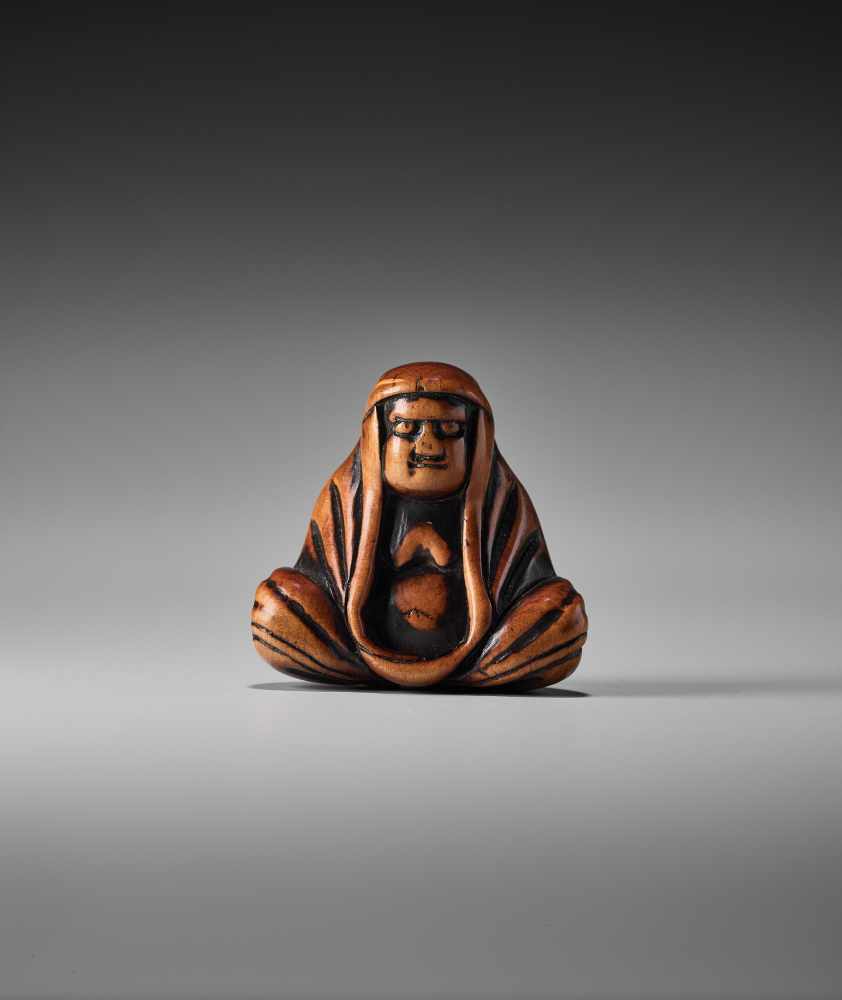 A WOOD NETSUKE OF A MEDITATING DARUMAUnsigned, wood netsukeJapan, 19th century, Edo period (1615-