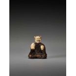 AN UNUSUAL WOOD AND IVORY NETSUKE OF A DRUNKEN ONI BY HOMINBy Homin, wood and ivory netsukeJapan,