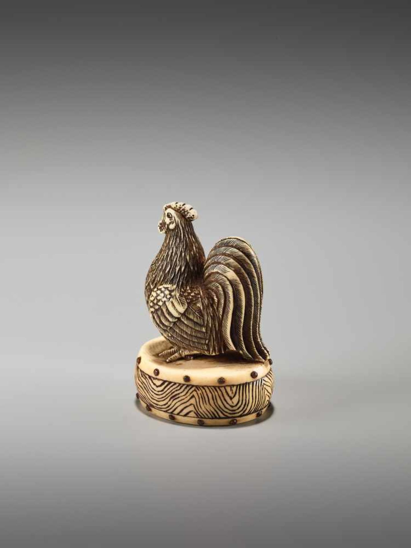 A FINE NETSUKE OF A COCKEREL ON A DRUM BY KOJITSU By Kojitsu, ivory netsuke with horn inlayJapan, - Image 2 of 12