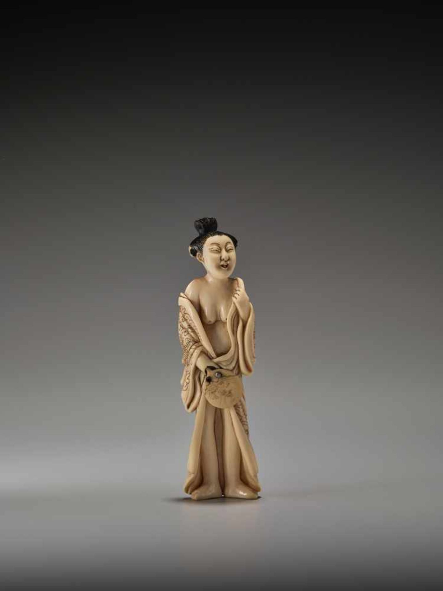 A RARE TALL IVORY SHUNGA NETSUKE OF A BIJINUnsigned, ivory shunga netsukeJapan, mid to late 19th