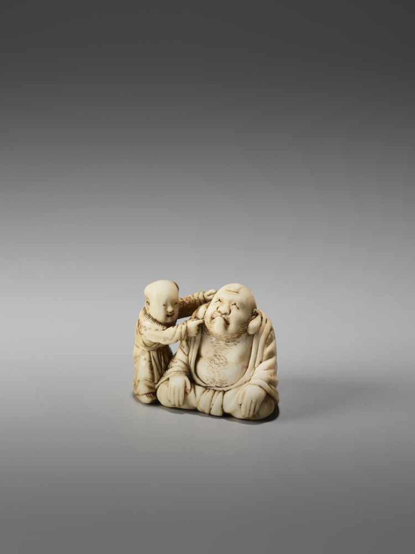 AN IVORY NETSUKE OF HOTEI PLAYING KAMIFUKI AND A KARAKO BY MINZANBy Minzan, ivory netsukeJapan,