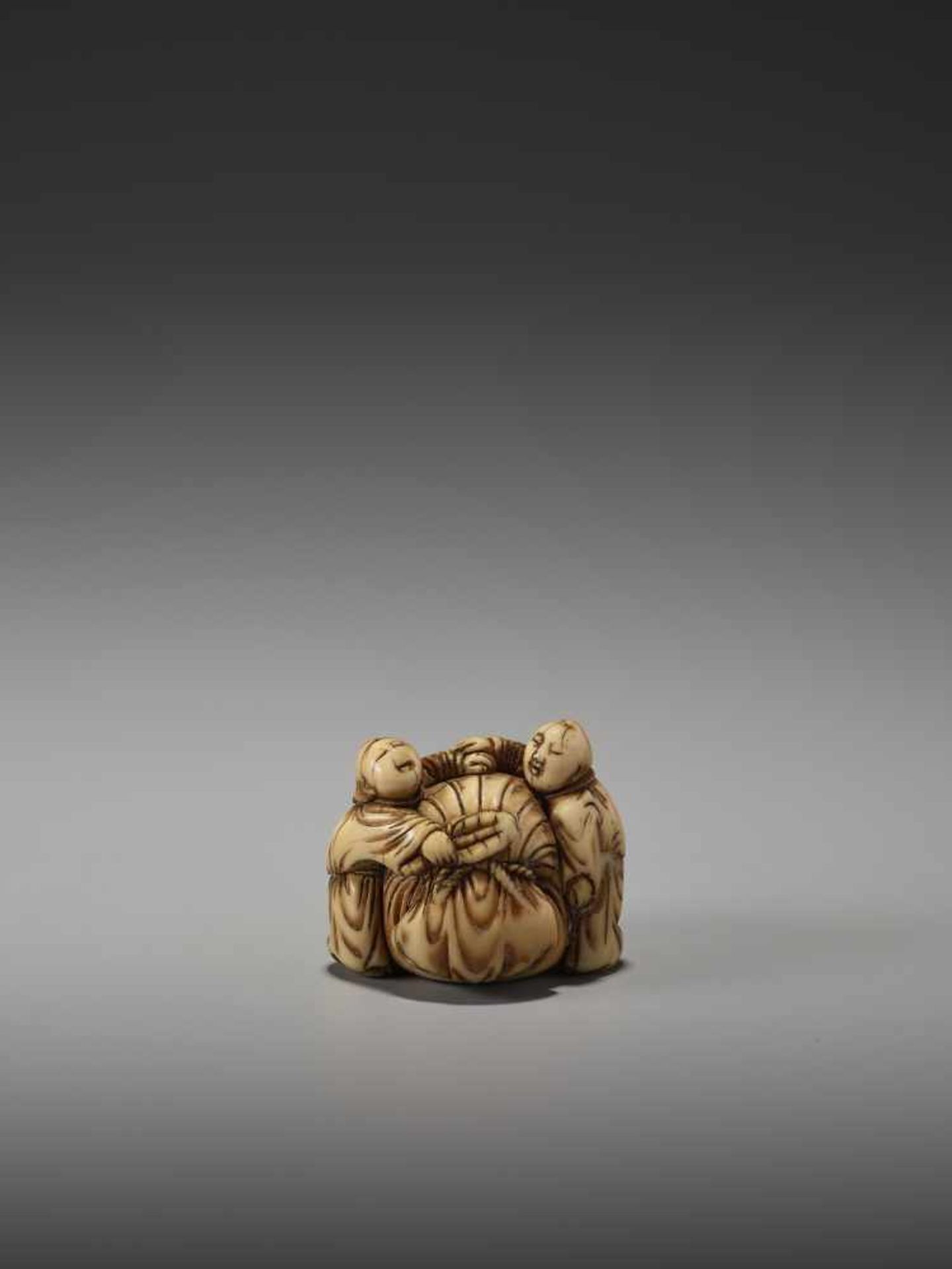 AN EARLY IVORY NETSUKE OF TWO CHINESE BOYS AND THE BAG OF HOTEIUnsigned, ivory netsukeJapan, mid-