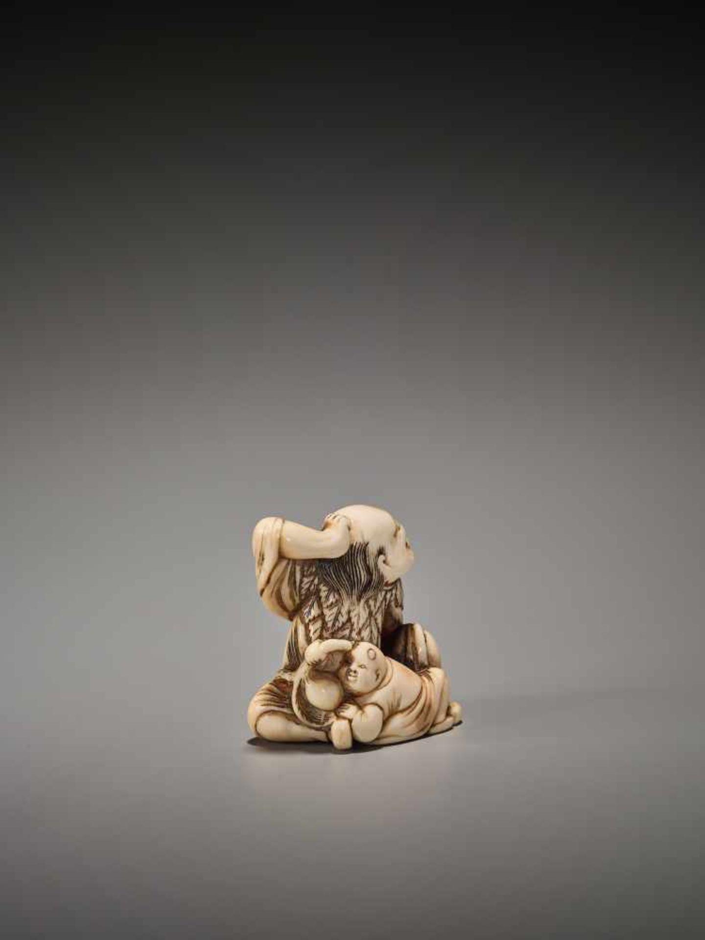 A POWERFUL IVORY NETSUKE OF A SENNIN WITH BOY AND PEACH Unsigned, ivory netsukeJapan, Kyoto, 18th - Image 5 of 6