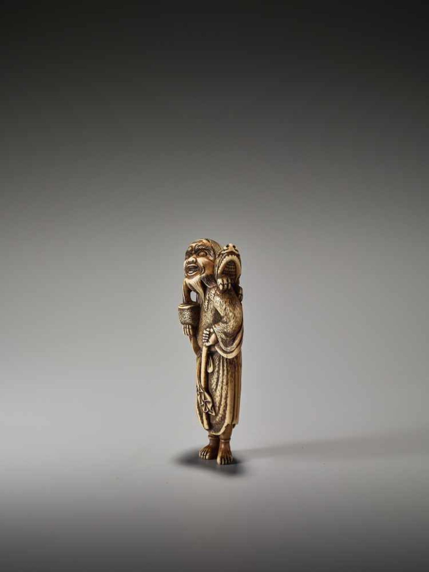 A POWERFUL TALL IVORY NETSUKE OF CHINNAN SENNIN WITH DRAGON AND TAMING STICKUnsigned, ivory - Image 4 of 6