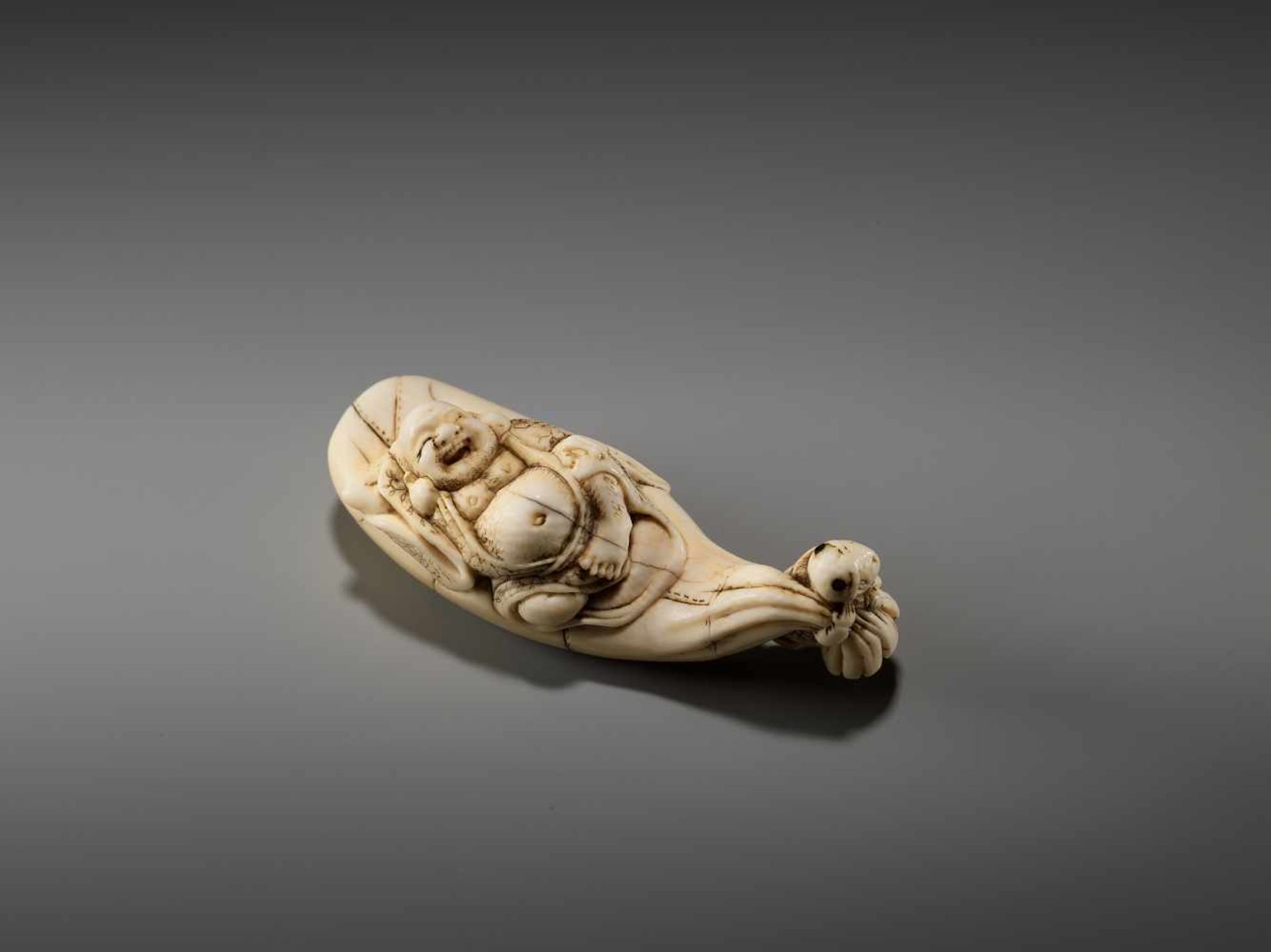 AN UNUSUAL IVORY NETSUKE OF HOTEI LAUGHING AND A BOY BY YASUHIDEBy Yasuhide, ivory netsukeJapan,