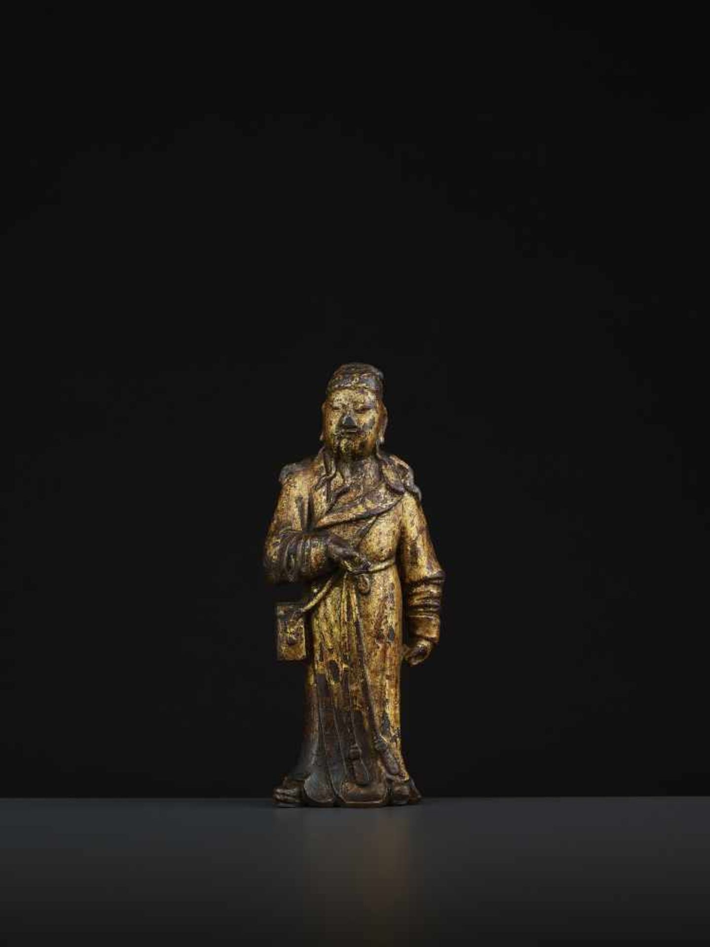 A MING DAOIST IMMORTAL BRONZEChina 16th - 17th century. The bronze with a rich gold lacquer coating.