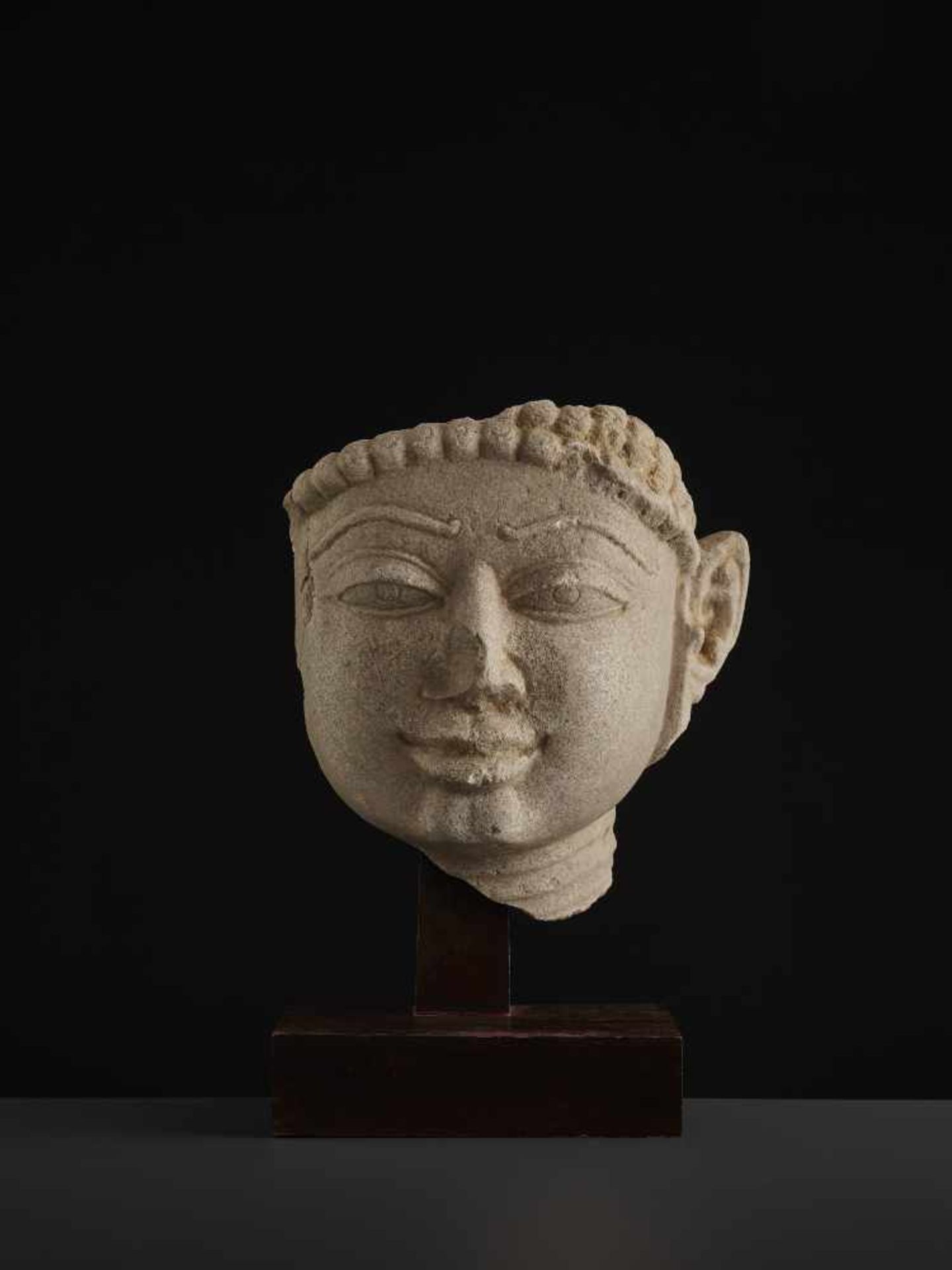 A SANDSTONE HEAD OF A TIRTHANKARACentral India, 11th - 13th century. A large and finely carved - Image 2 of 9