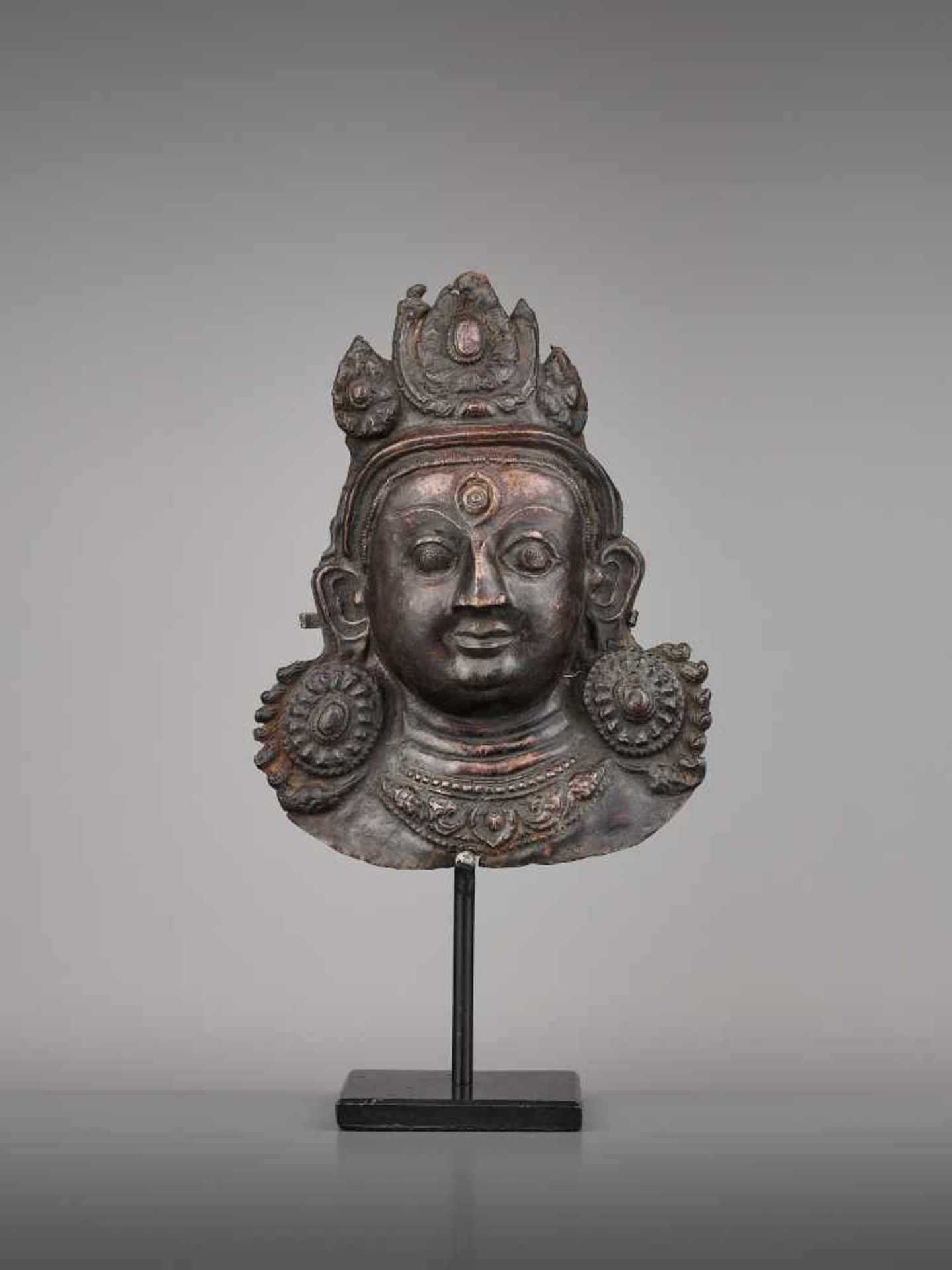 A COPPER REPOUSSE MASK OF BHAIRAVA Nepal, 17th century. The expressive copper mask with well-