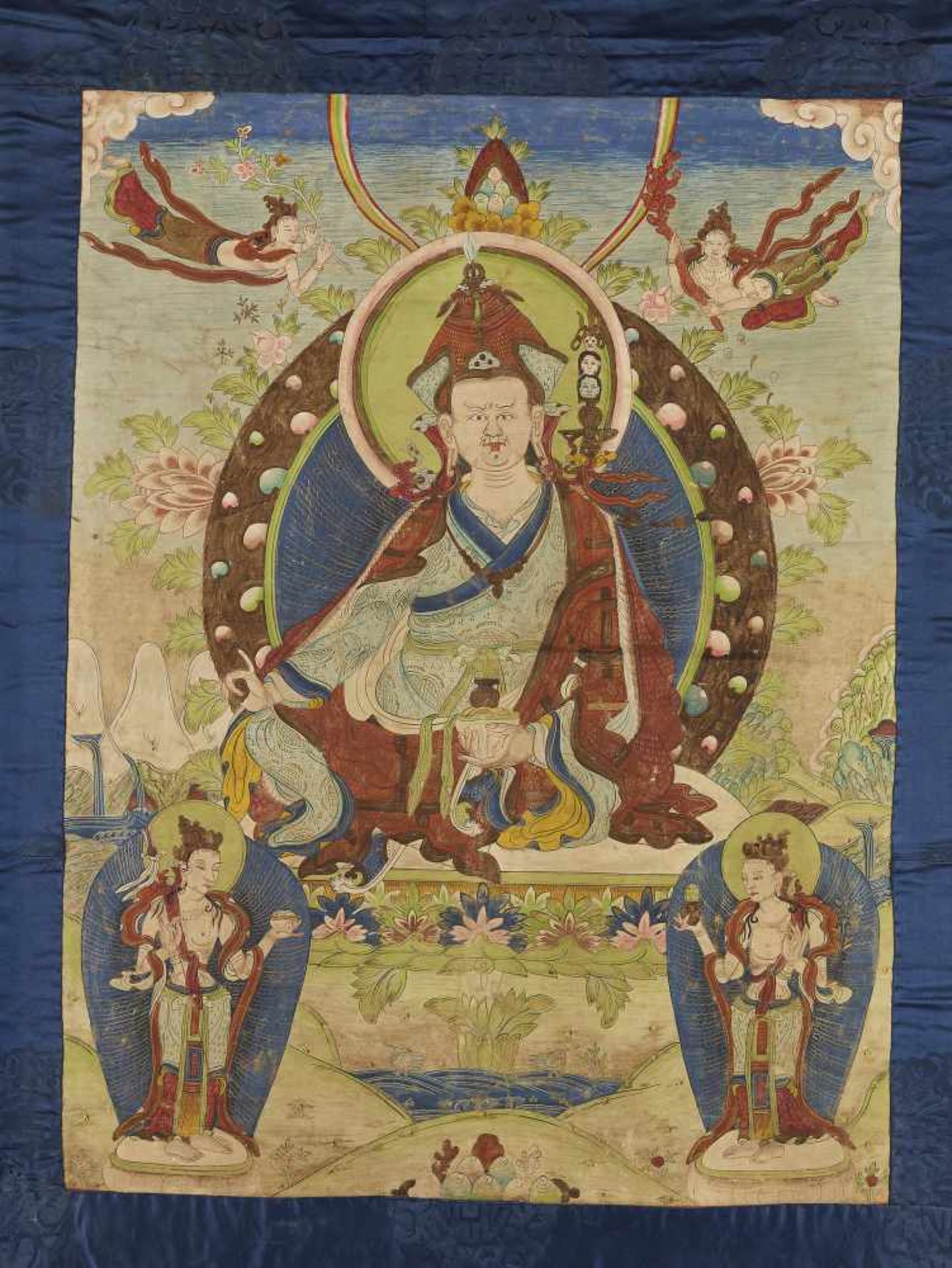 A PADMASAMBHAVA THANGKA EARLY 1800sTibet, circa 1800. Seated on a throne, his hands in varada- and