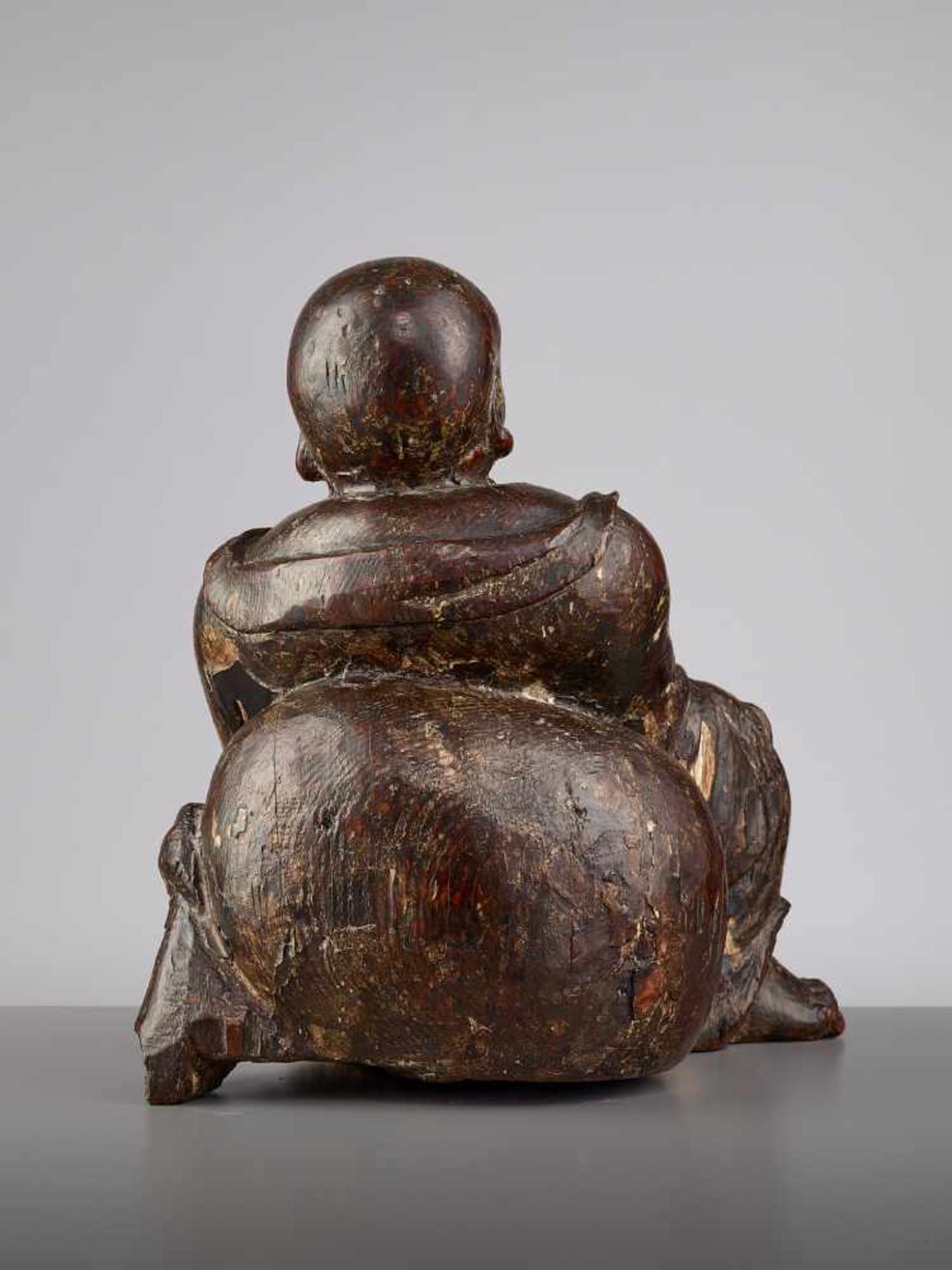 AN EXPRESSIVE WOOD BUDAI, MINGChina, 15th - 16th century. This earthy yet radiant sculpture of Budai - Image 6 of 9