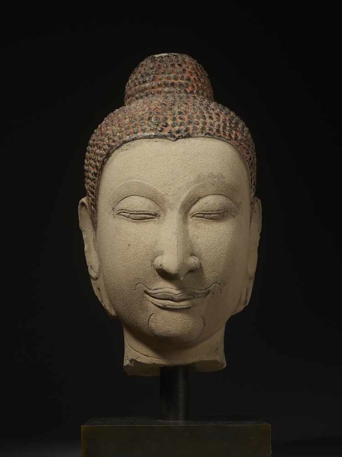 AN IMPORTANT VERY LARGE BUDDHA HEAD Thailand, Ayutthaya, 15th century. Masterly carved sandstone