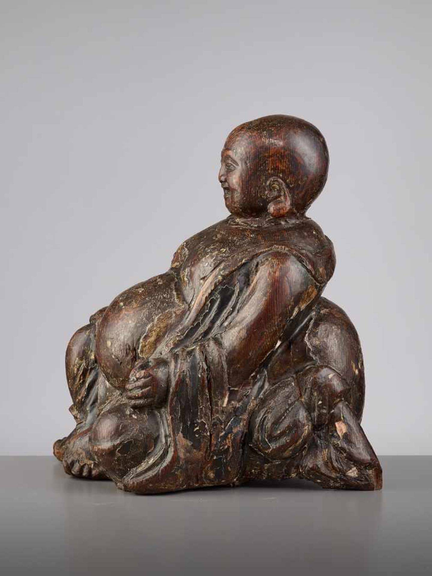 AN EXPRESSIVE WOOD BUDAI, MINGChina, 15th - 16th century. This earthy yet radiant sculpture of Budai - Image 5 of 9