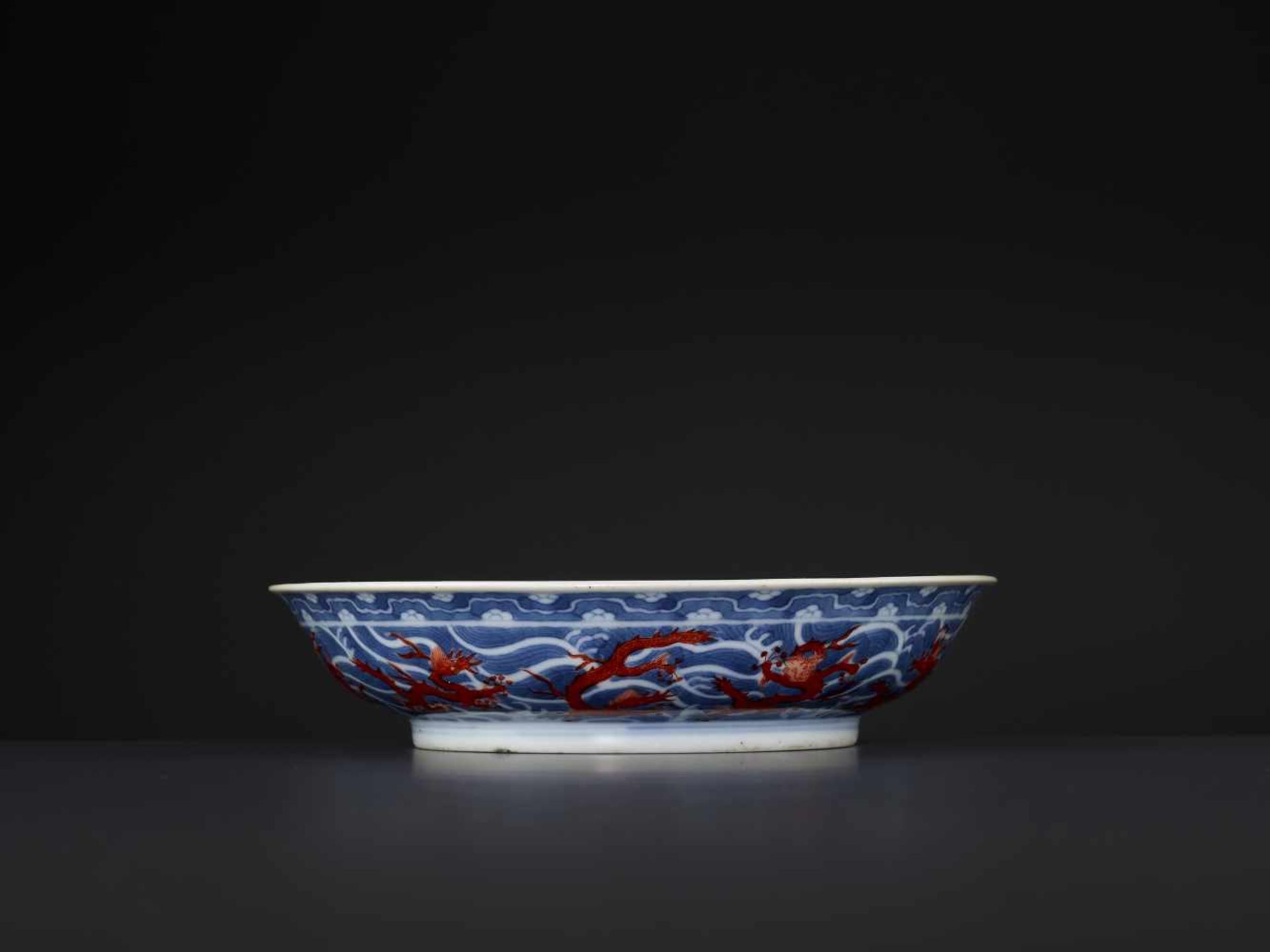 A DAOGUANG MARK & PERIOD DRAGON DISHChina, 1821-1850. Porcelain painted in iron red and underglaze- - Image 9 of 10