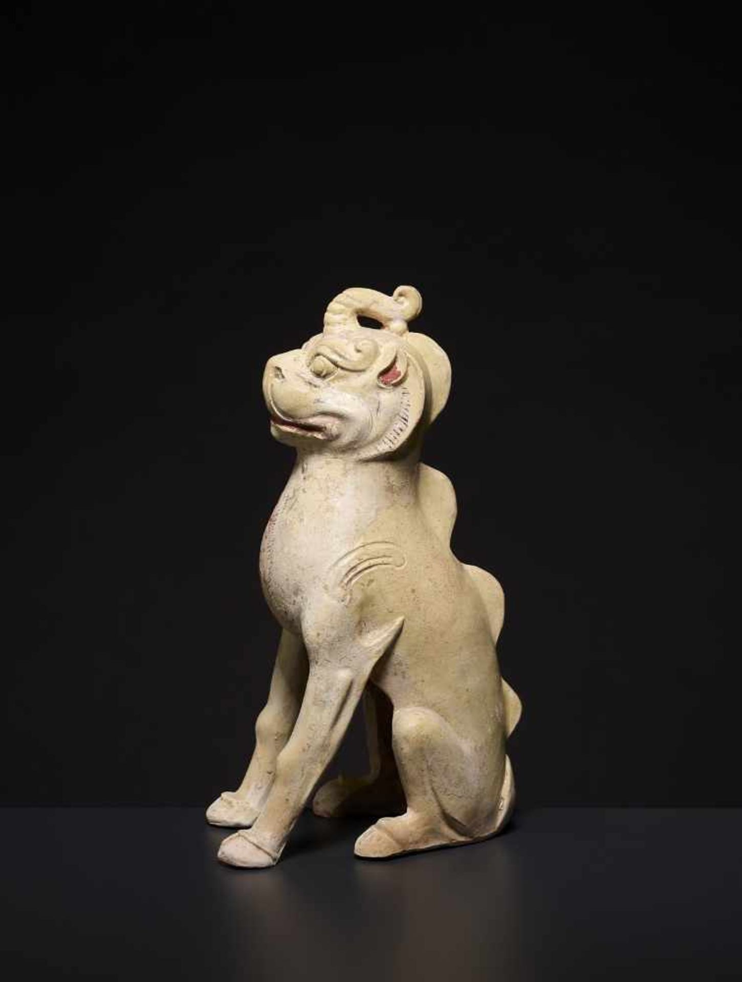 A GLAZED CERAMIC UNICORN, TANG China, 618-907. The pottery statue neatly modelled with the unicorn