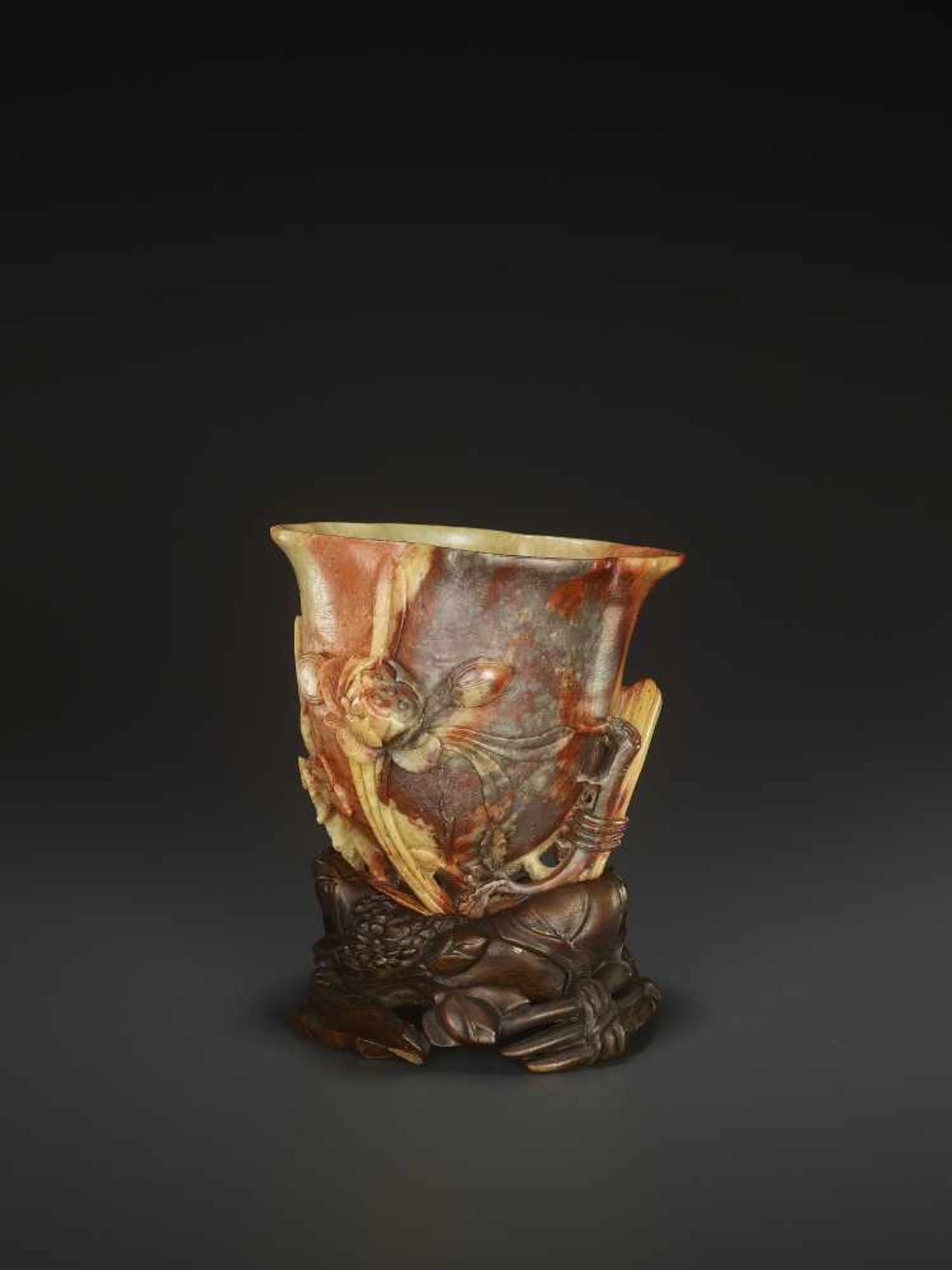 A SOAPSTONE LIBATION CUP, QINGChina, late 18th- mid-19th century. With matching carved hardwood