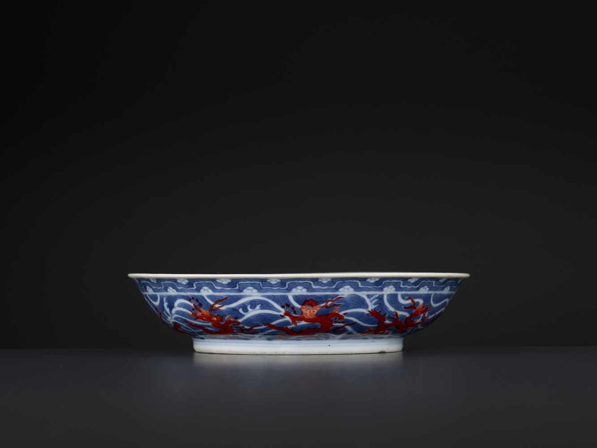 A DAOGUANG MARK & PERIOD DRAGON DISHChina, 1821-1850. Porcelain painted in iron red and underglaze- - Image 8 of 10