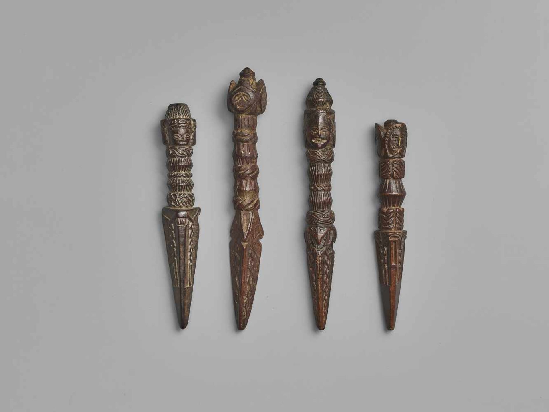 FOUR NEPALESE CARVED WOOD PHURBUSNepal, 17th-19th century. This lot comprises four phurbus, each