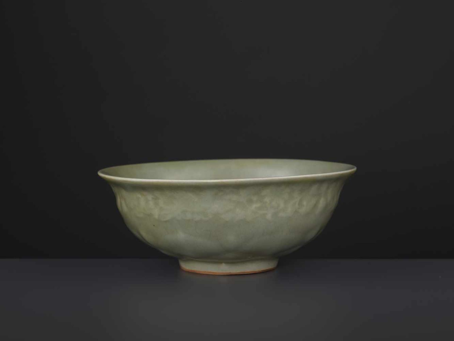 A CARVED LONQUAN LOTUS BOWL, MINGChina, 16th/17th century. Covered overall (except the foot rim)