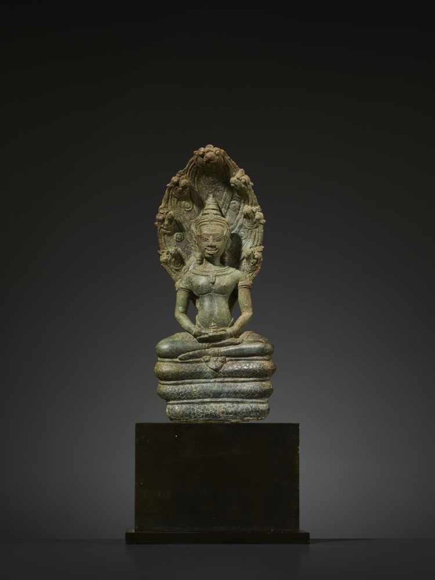 A KHMER BRONZE BUDDHA MUCHALINDA Cambodia, Angkor period, 12th century. Finely cast and incised
