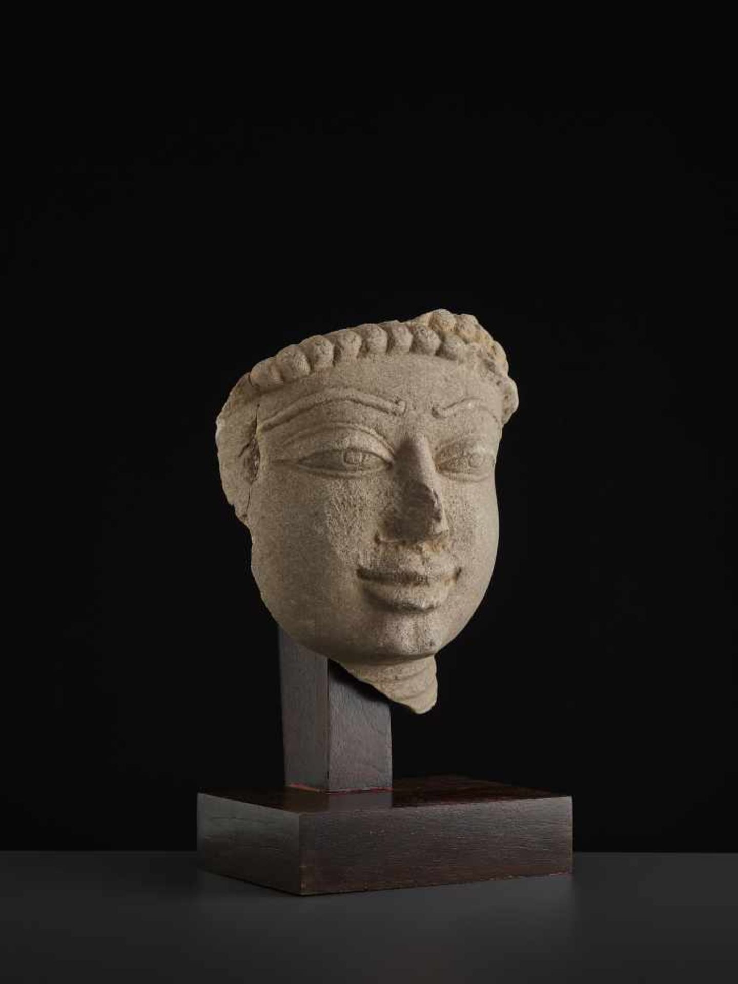 A SANDSTONE HEAD OF A TIRTHANKARACentral India, 11th - 13th century. A large and finely carved - Image 7 of 9