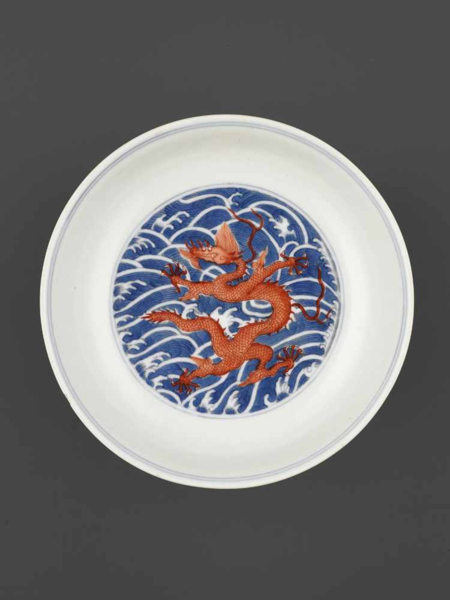 A DAOGUANG MARK & PERIOD DRAGON DISHChina, 1821-1850. Porcelain painted in iron red and underglaze-