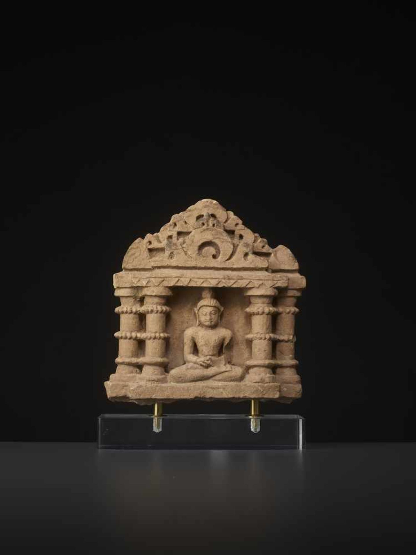 A SANDSTONE STELE OF TIRTHANKARA Central India, 13th - 15th century. Deep relief with tirthankara