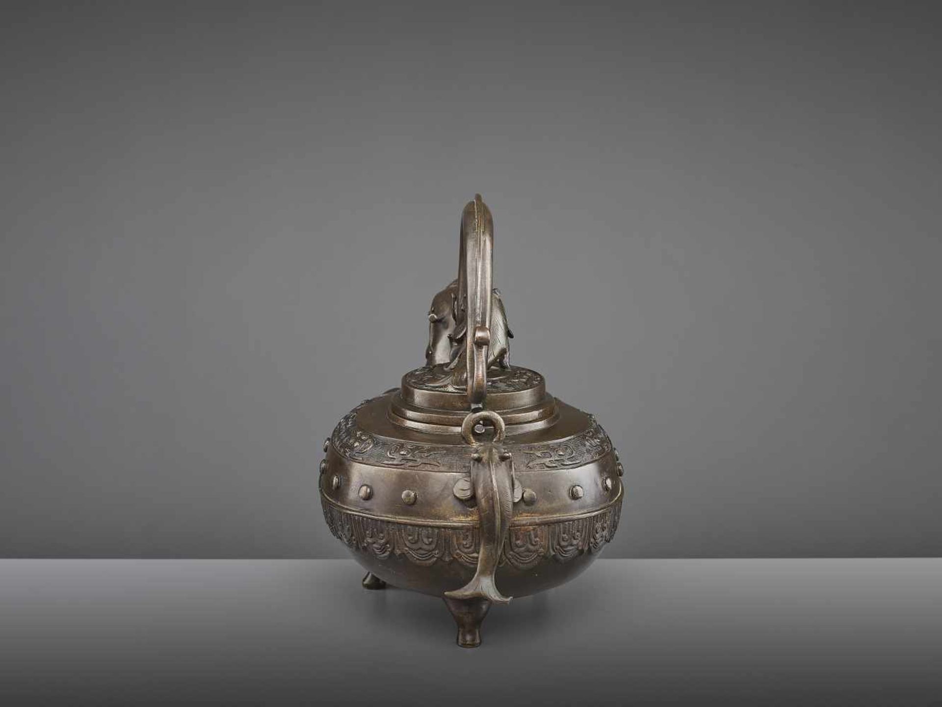 A BRONZE DRAGON EWER, QING China, 18th - 19th century. The lidded tripod vessel with a dragon head - Image 3 of 9