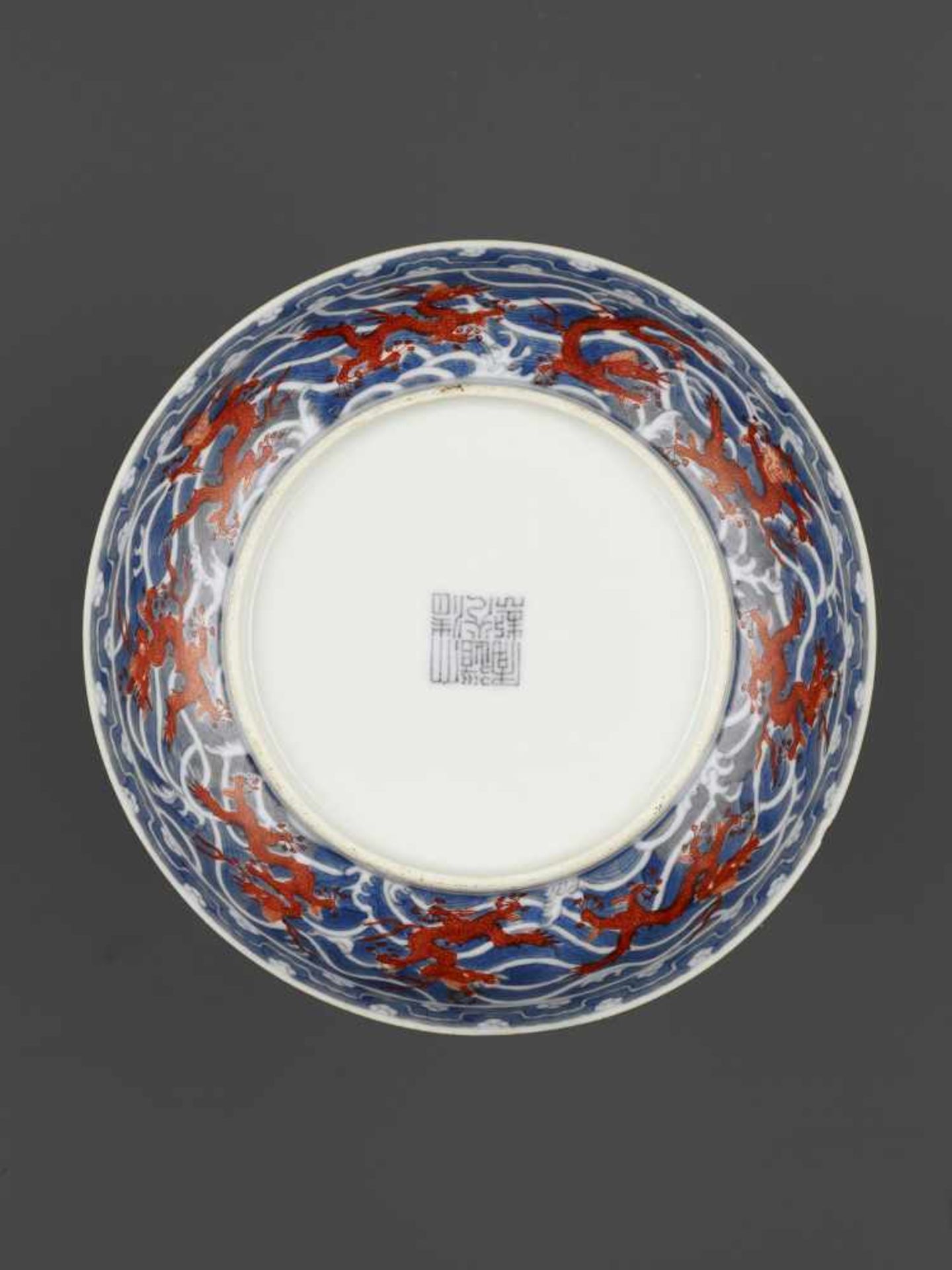 A DAOGUANG MARK & PERIOD DRAGON DISHChina, 1821-1850. Porcelain painted in iron red and underglaze- - Image 4 of 10