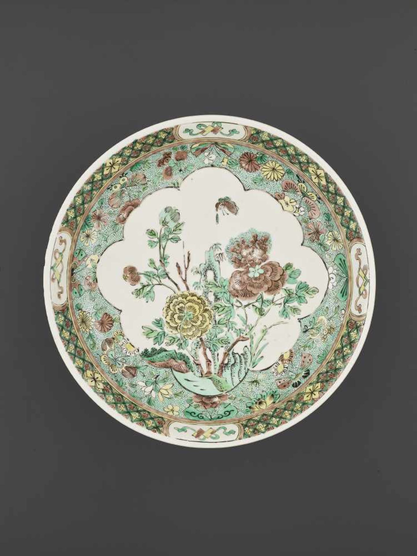 A KANGXI FAMILLE VERTE BISCUIT DISHChina, 1662-1722. Painted in green, yellow and aubergine