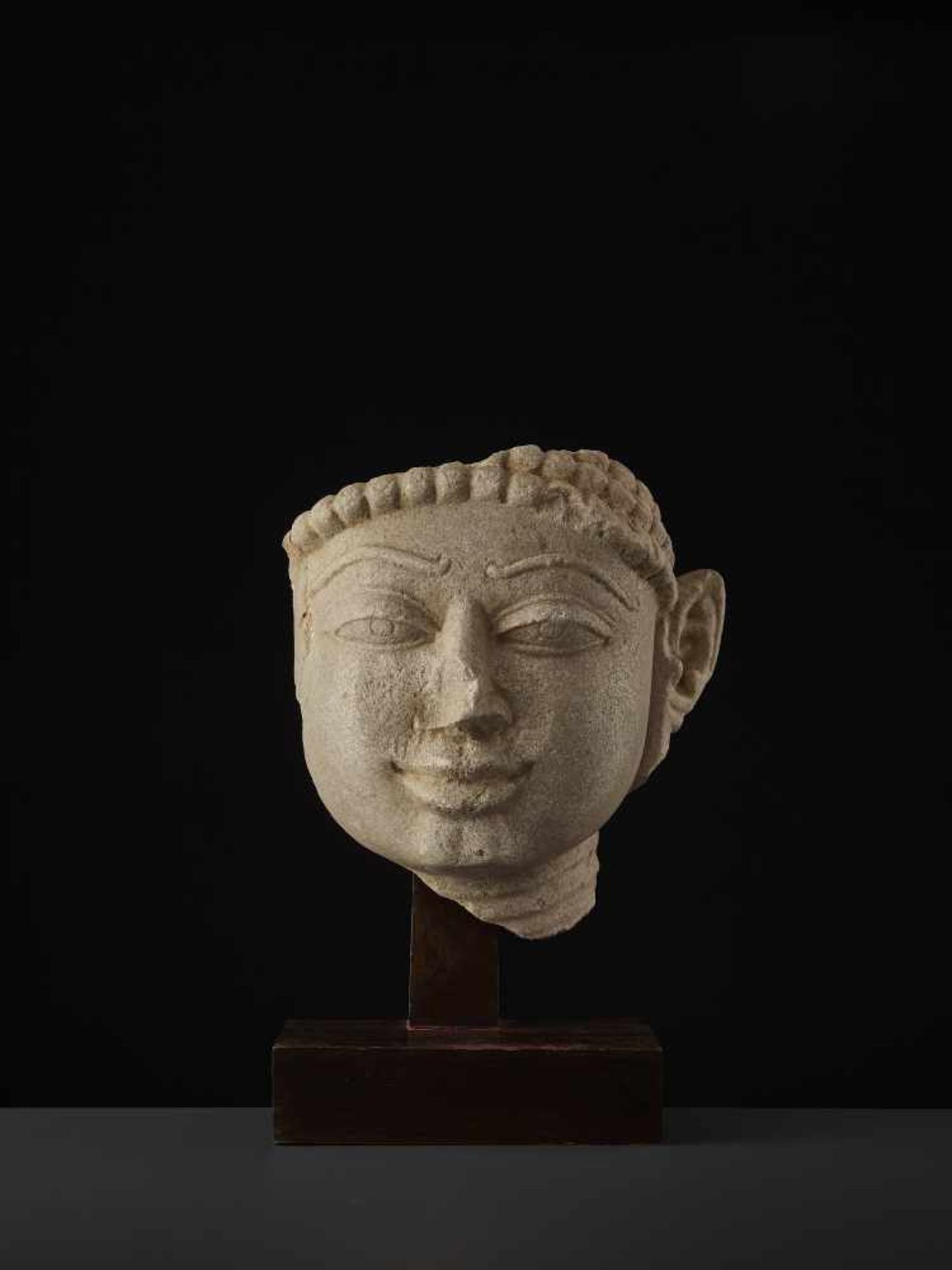 A SANDSTONE HEAD OF A TIRTHANKARACentral India, 11th - 13th century. A large and finely carved - Image 5 of 9