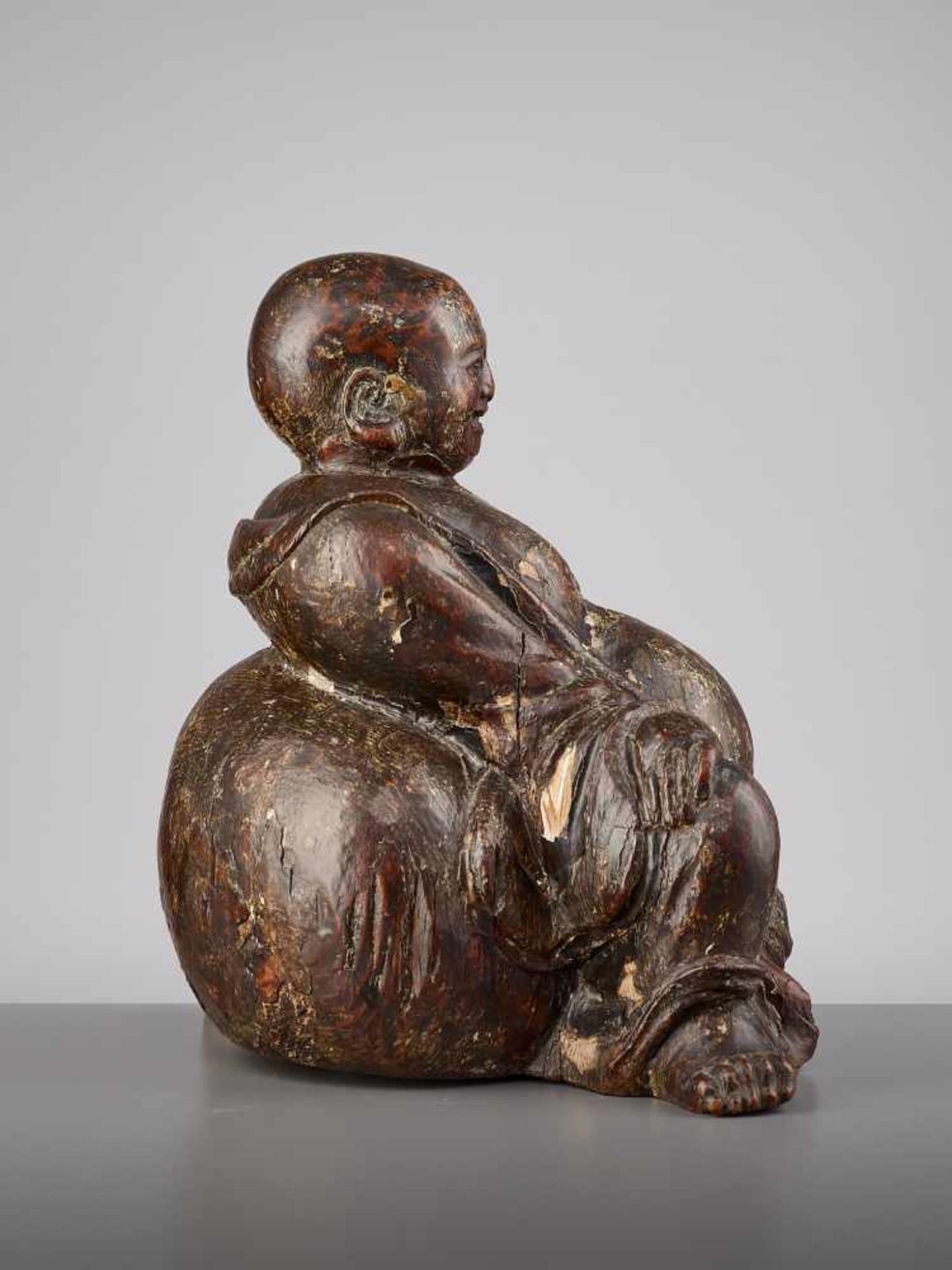 AN EXPRESSIVE WOOD BUDAI, MINGChina, 15th - 16th century. This earthy yet radiant sculpture of Budai - Image 7 of 9
