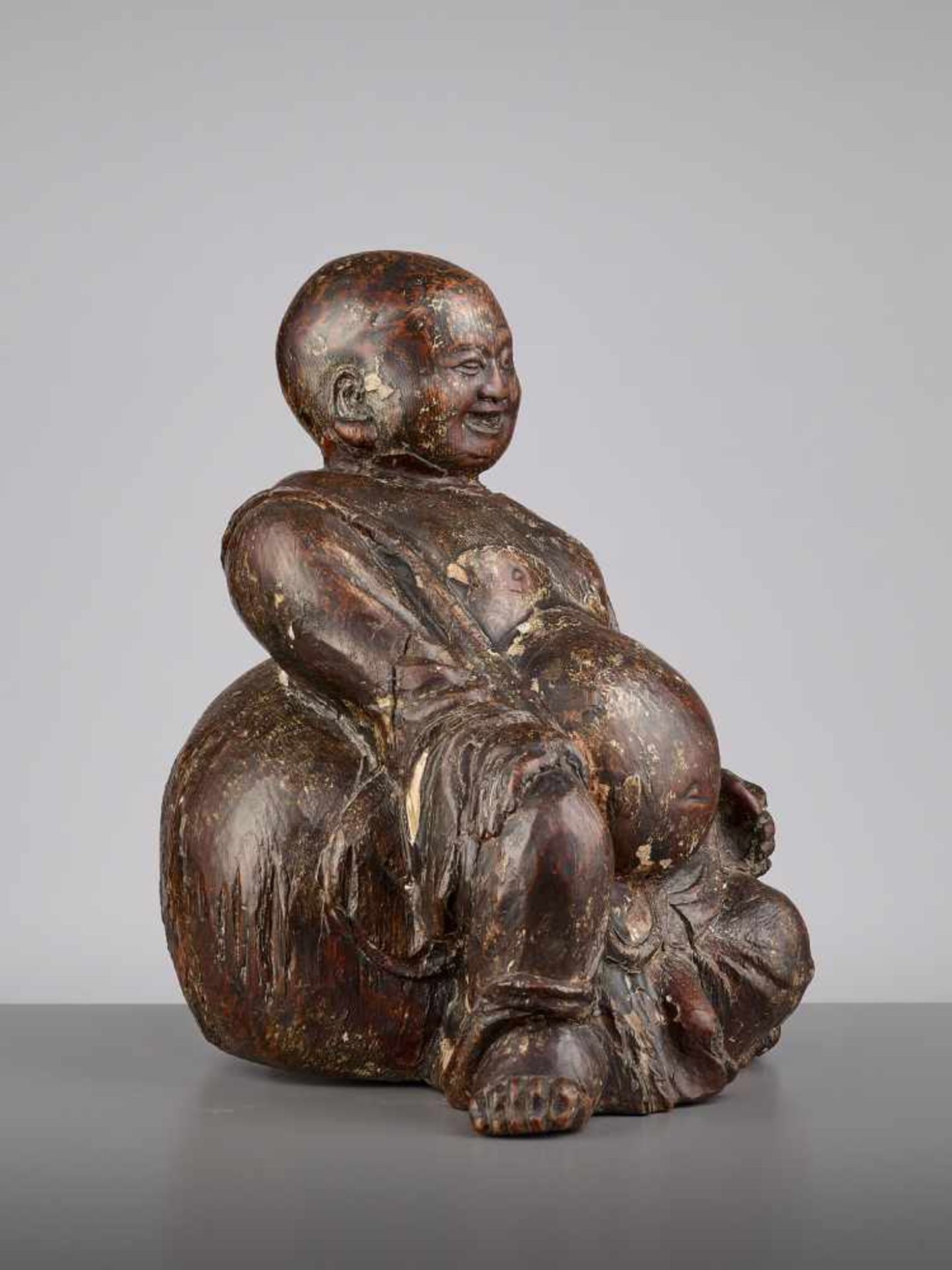 AN EXPRESSIVE WOOD BUDAI, MINGChina, 15th - 16th century. This earthy yet radiant sculpture of Budai - Image 8 of 9