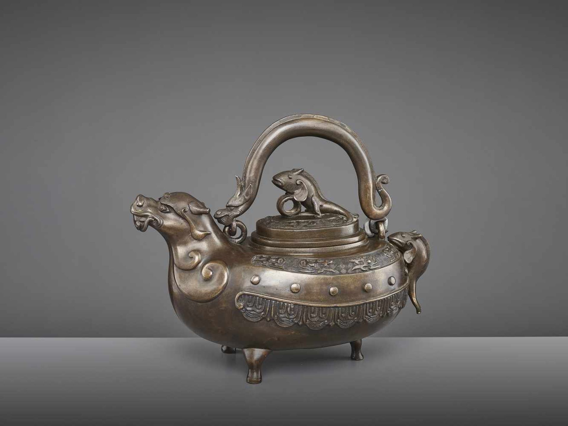 A BRONZE DRAGON EWER, QING China, 18th - 19th century. The lidded tripod vessel with a dragon head