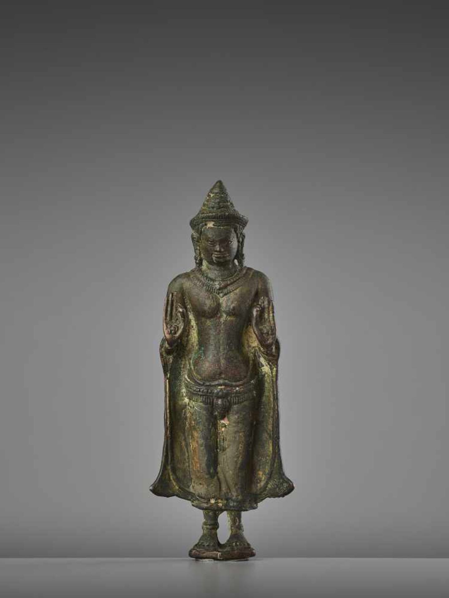 A KHMER LOPBURI BRONZE BUDDHAThailand, 13th century. The neatly cast figure with fine incisions