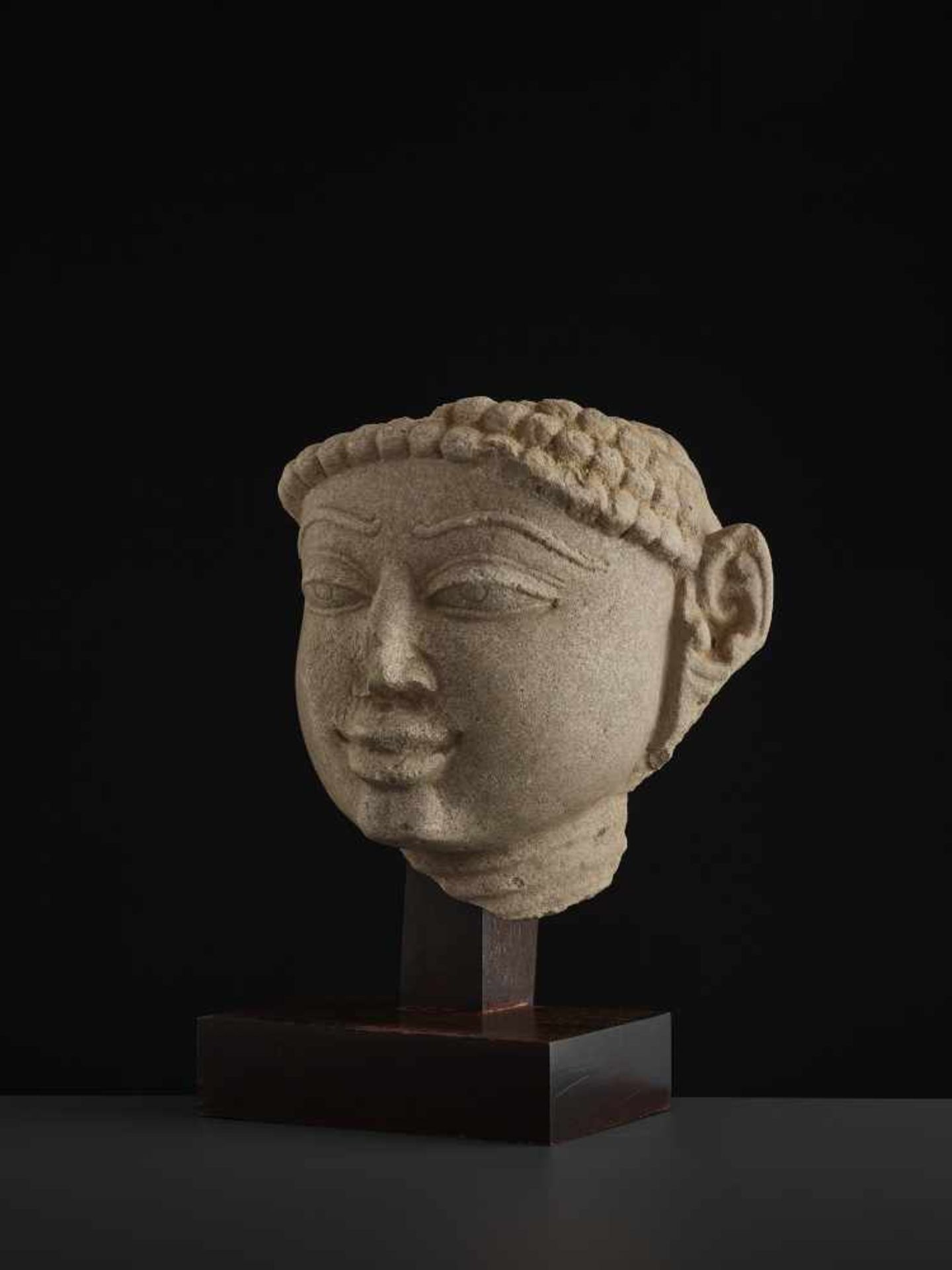 A SANDSTONE HEAD OF A TIRTHANKARACentral India, 11th - 13th century. A large and finely carved - Image 3 of 9